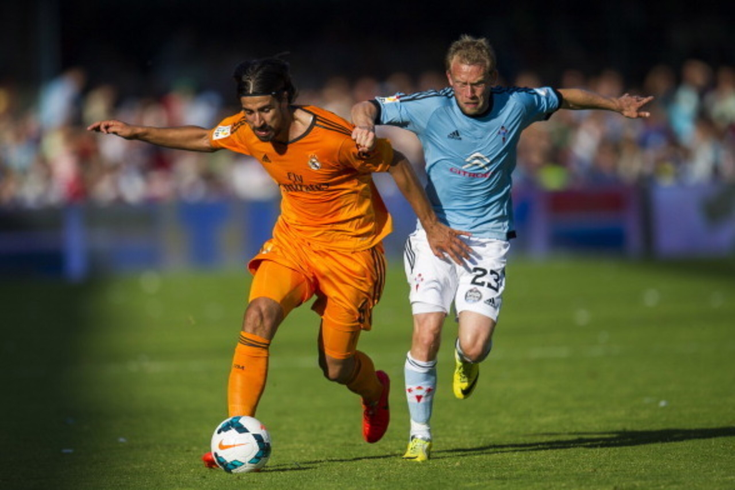 VIGO, SPAIN - MAY 11: Sami Khedira of Real Madrid CF duels for the ball with Michael Krohn-Dehli of RC Celta De Vigo during the la Liga match between Real Club Celta De Vigo and Real Madrid CF at Estadio Balaidos on May 11, 2014 in Vigo, Spain. (Photo b VIGO, SPAIN - MAY 11: Sami Khedira of Real Madrid CF duels for the ball with Michael Krohn-Dehli of RC Celta De Vigo during the la Liga match between Real Club Celta De Vigo and Real Madrid CF at Estadio Balaidos on May 11, 2014 in Vigo, Spain. (Photo b