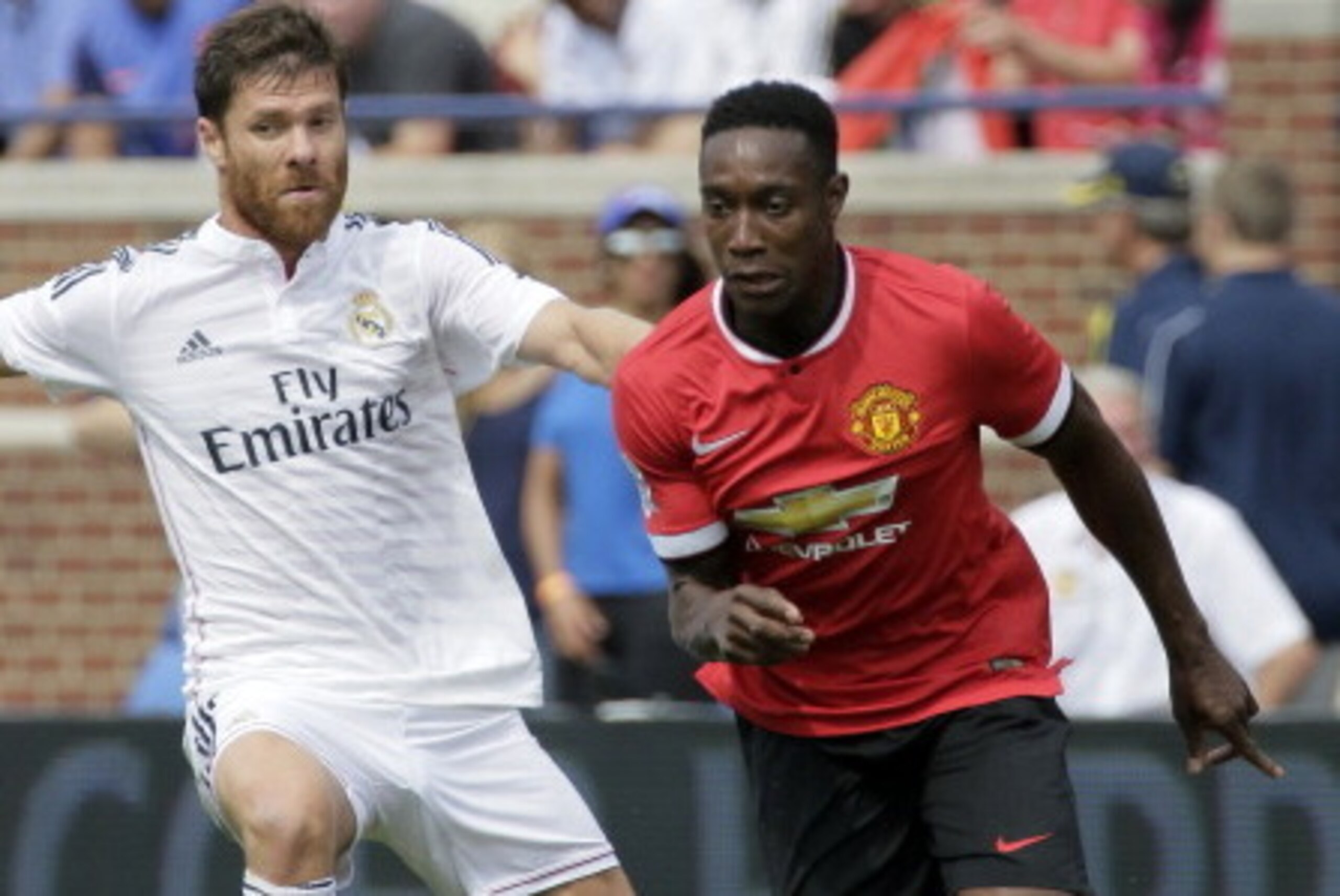 ANN ARBOR, MI - AUGUST 2: Xabi Alonso #14 of Real Madrid tries to maintain control of the ball against Danny Welbeck #19 of Manchester United during the first half of the Guinness International Champions Cup at Michigan Stadium on August 2, 2014, in Ann ANN ARBOR, MI - AUGUST 2: Xabi Alonso #14 of Real Madrid tries to maintain control of the ball against Danny Welbeck #19 of Manchester United during the first half of the Guinness International Champions Cup at Michigan Stadium on August 2, 2014, in Ann