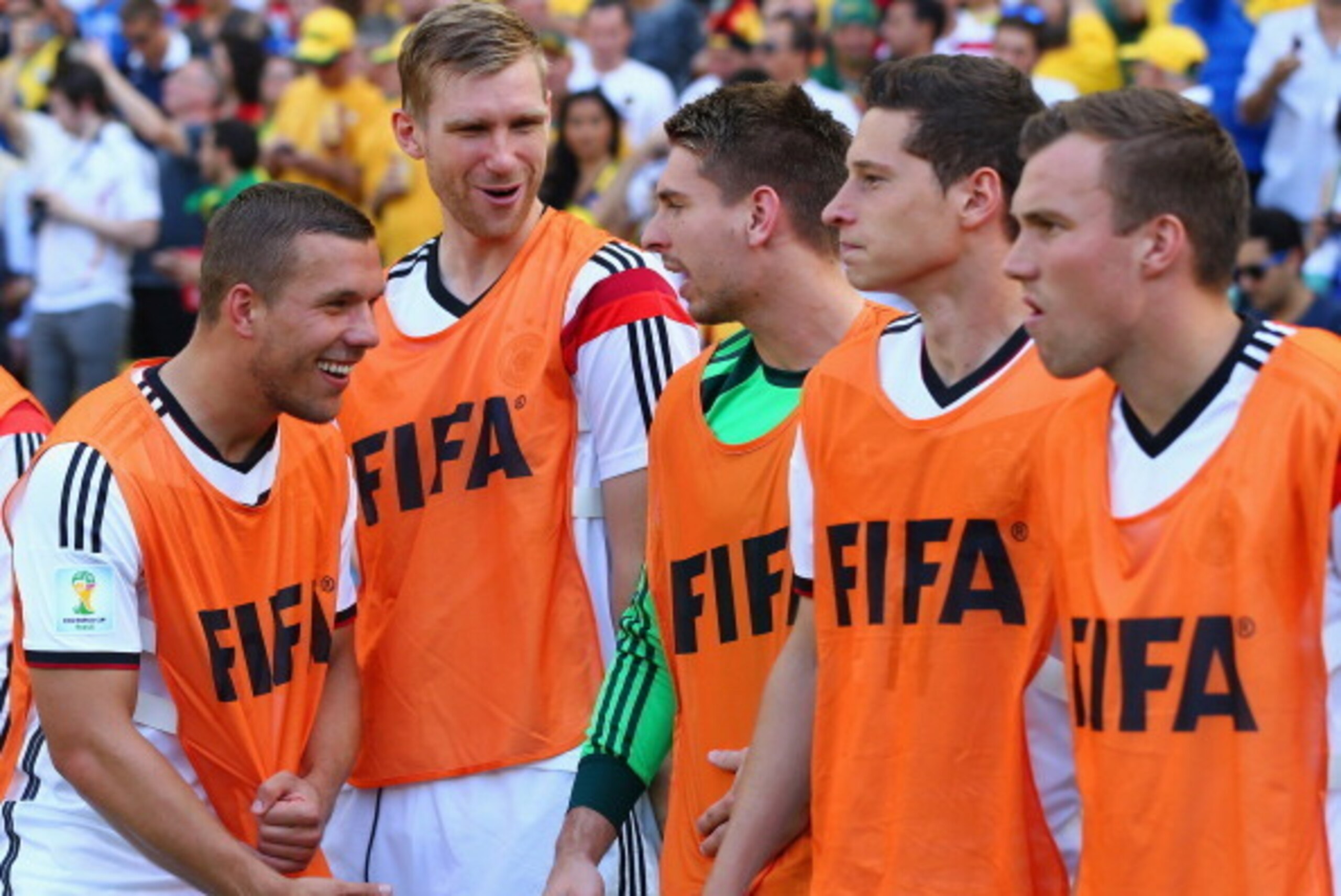 RIO DE JANEIRO, BRAZIL - JULY 04:  Lukas Podolski (L) and Per Mertesacker of Germany (2nd L) look on with teammates from the bench during the 2014 FIFA World Cup Brazil Quarter Final match between France and Germany at Maracana on July 4, 2014 in Rio de J