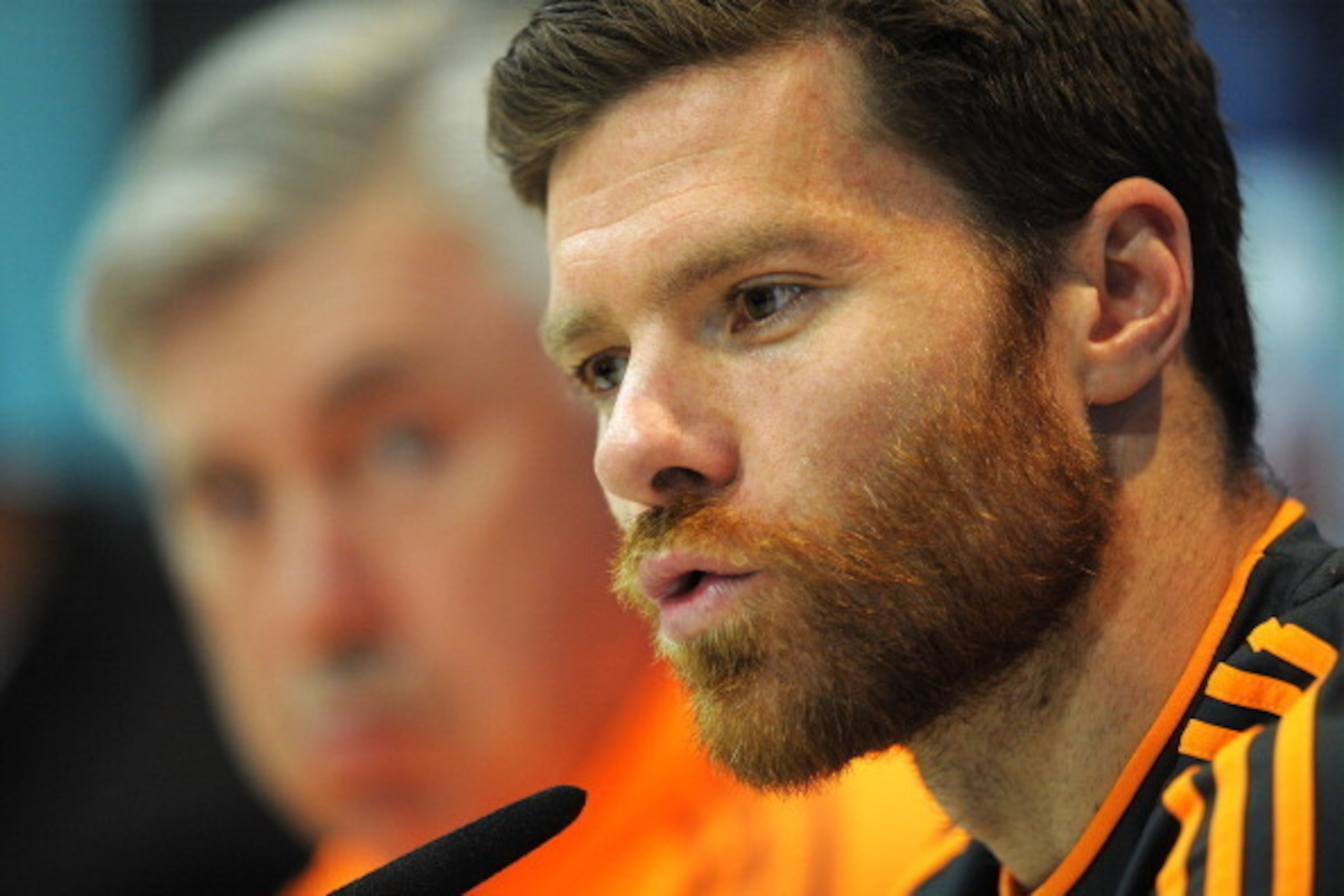 MADRID, SPAIN - APRIL 22:  Xabi Alonso (R) of Real Madrid CF answers a question beside head coach Carlo Ancelotti during their press conference at Valdebebas training ground ahead of the UEFA Champions League semi-final first leg match against Bayern Muni