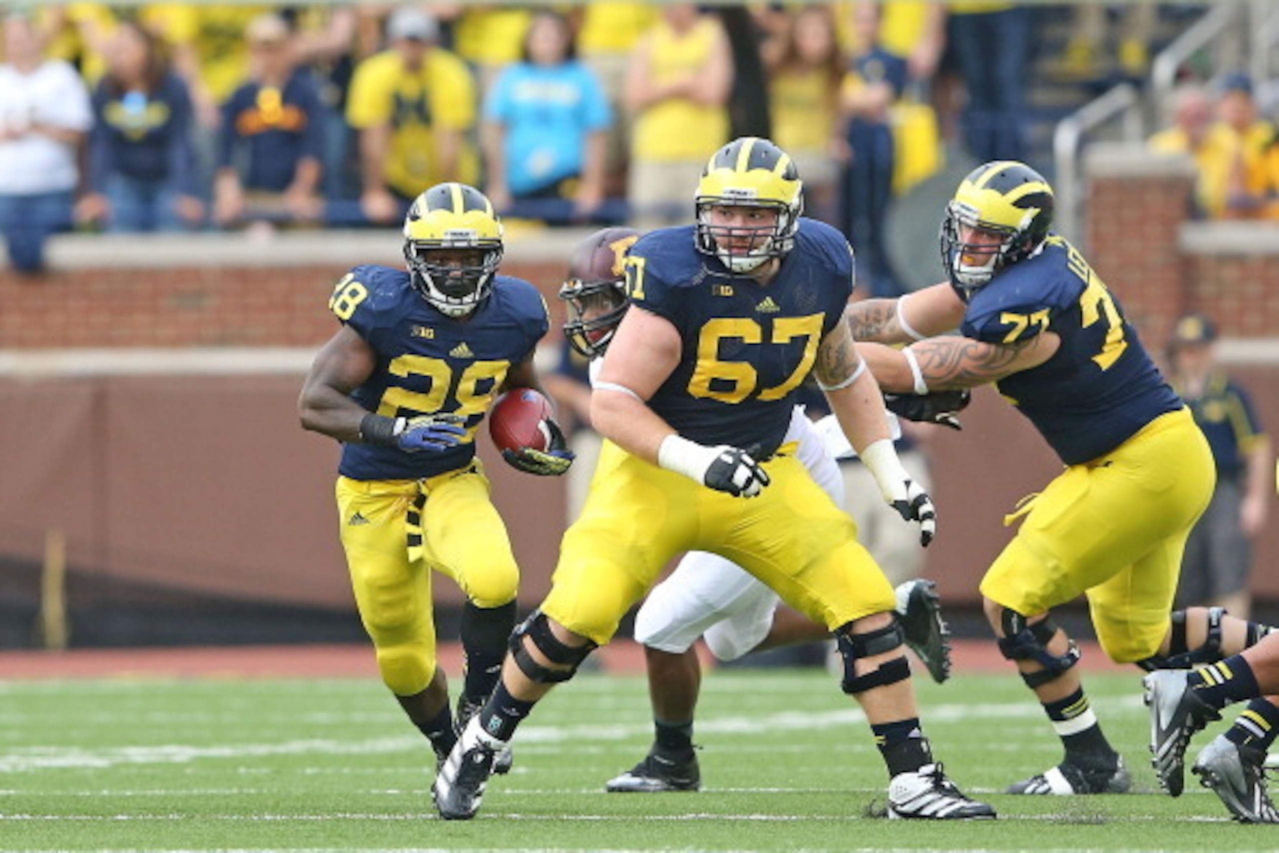 ANN ARBOR, MI - OCTOBER 05: Fitzgerald Toussaint #28 of the Michigan Wolverines runs for a short gain as Kyle Kalis #67 blocks during the second quarter of the game against the Minnesota Golden Gophers at Michigan Stadium on October 5, 2013 in Ann Arbor, ANN ARBOR, MI - OCTOBER 05: Fitzgerald Toussaint #28 of the Michigan Wolverines runs for a short gain as Kyle Kalis #67 blocks during the second quarter of the game against the Minnesota Golden Gophers at Michigan Stadium on October 5, 2013 in Ann Arbor,