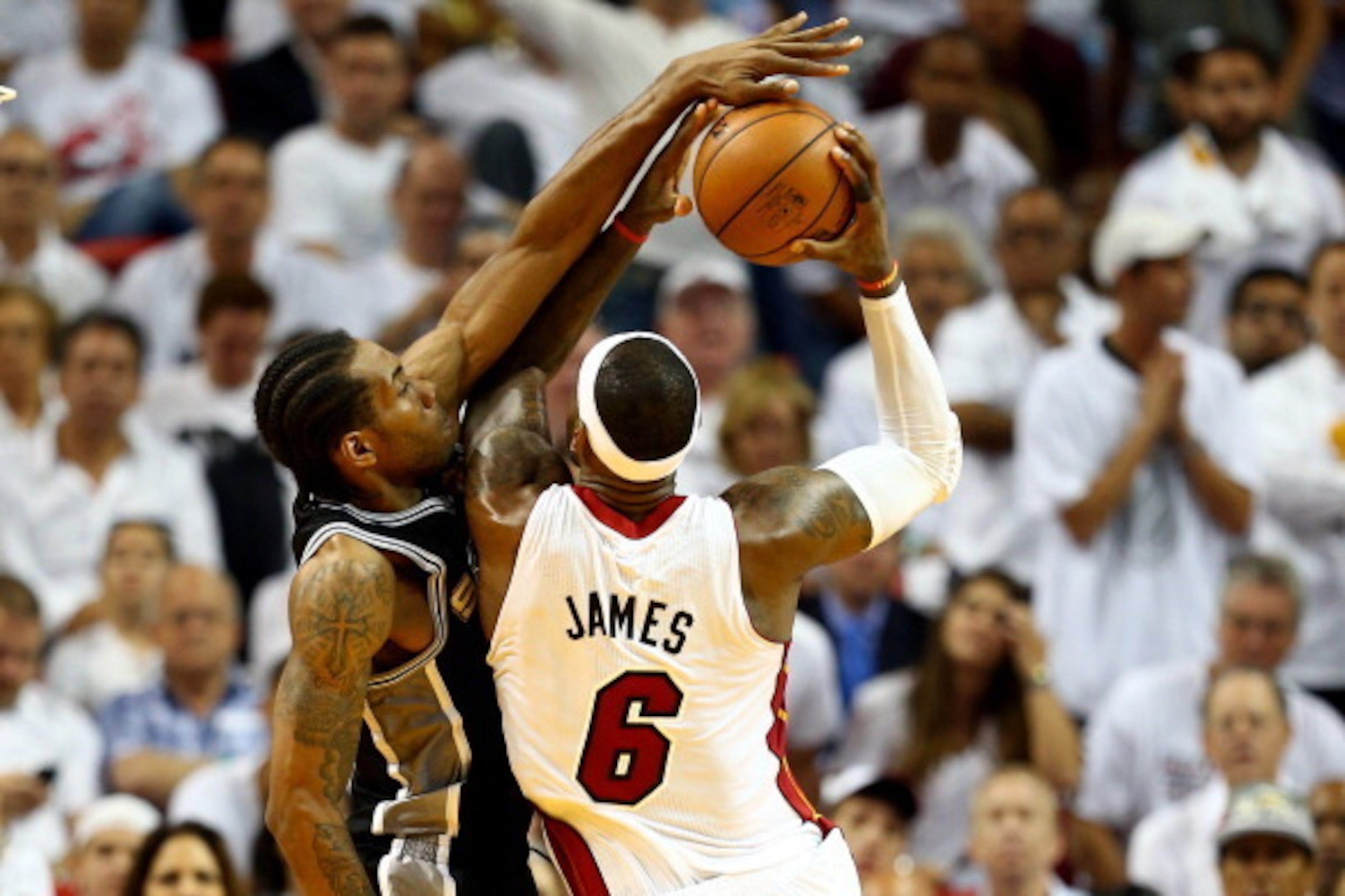 MIAMI, FL - JUNE 12:  Kawhi Leonard #2 of the San Antonio Spurs blocks LeBron James #6 of the Miami Heat during Game Four of the 2014 NBA Finals at American Airlines Arena on June 12, 2014 in Miami, Florida. NOTE TO USER: User expressly acknowledges and a