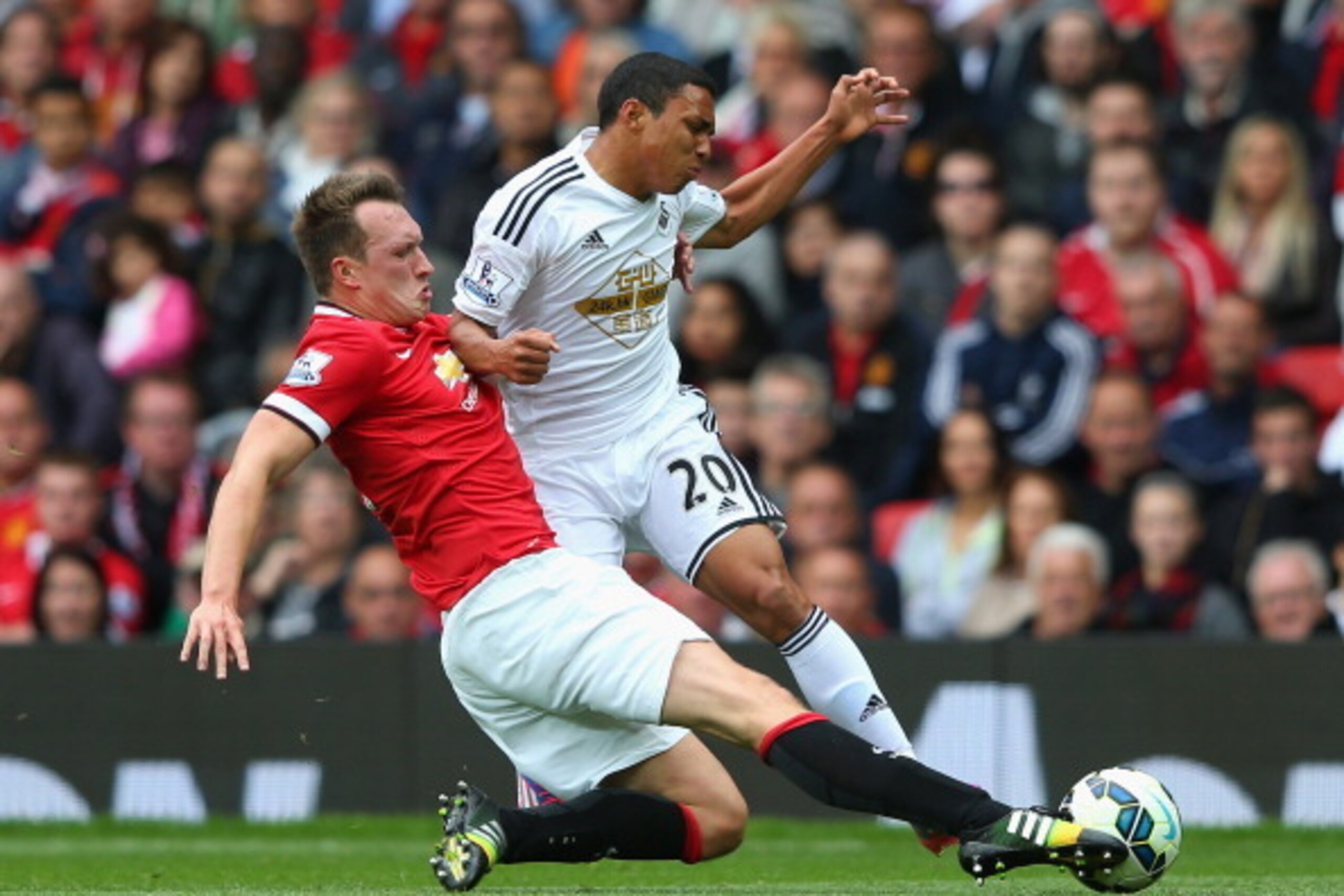 MANCHESTER, ENGLAND - AUGUST 16: Phil Jones of Manchester United tackles Jefferson Montero of Swansea City during the Barclays Premier League match between Manchester United and Swansea City at Old Trafford on August 16, 2014 in Manchester, England. (Ph MANCHESTER, ENGLAND - AUGUST 16: Phil Jones of Manchester United tackles Jefferson Montero of Swansea City during the Barclays Premier League match between Manchester United and Swansea City at Old Trafford on August 16, 2014 in Manchester, England. (Ph