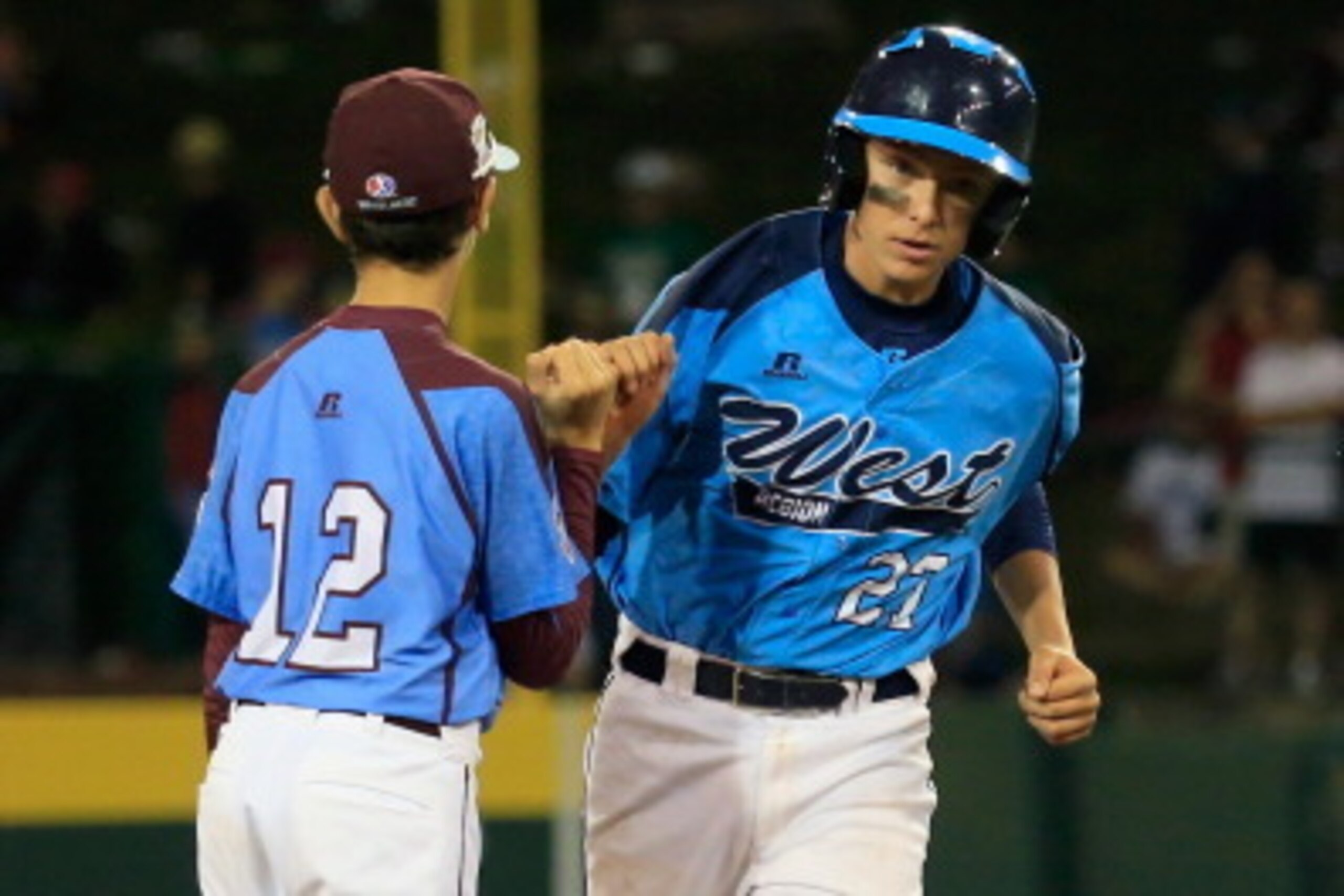 SOUTH WILLIAMSPORT, PA - AUGUST 20:  Brennan Holligan #27  of Nevada is congratulated by shortstop Jared Sprague-Lott of Pennsylvania after hitting a two RBI home run during the sixth inning of the United States division game at the Little League World Se