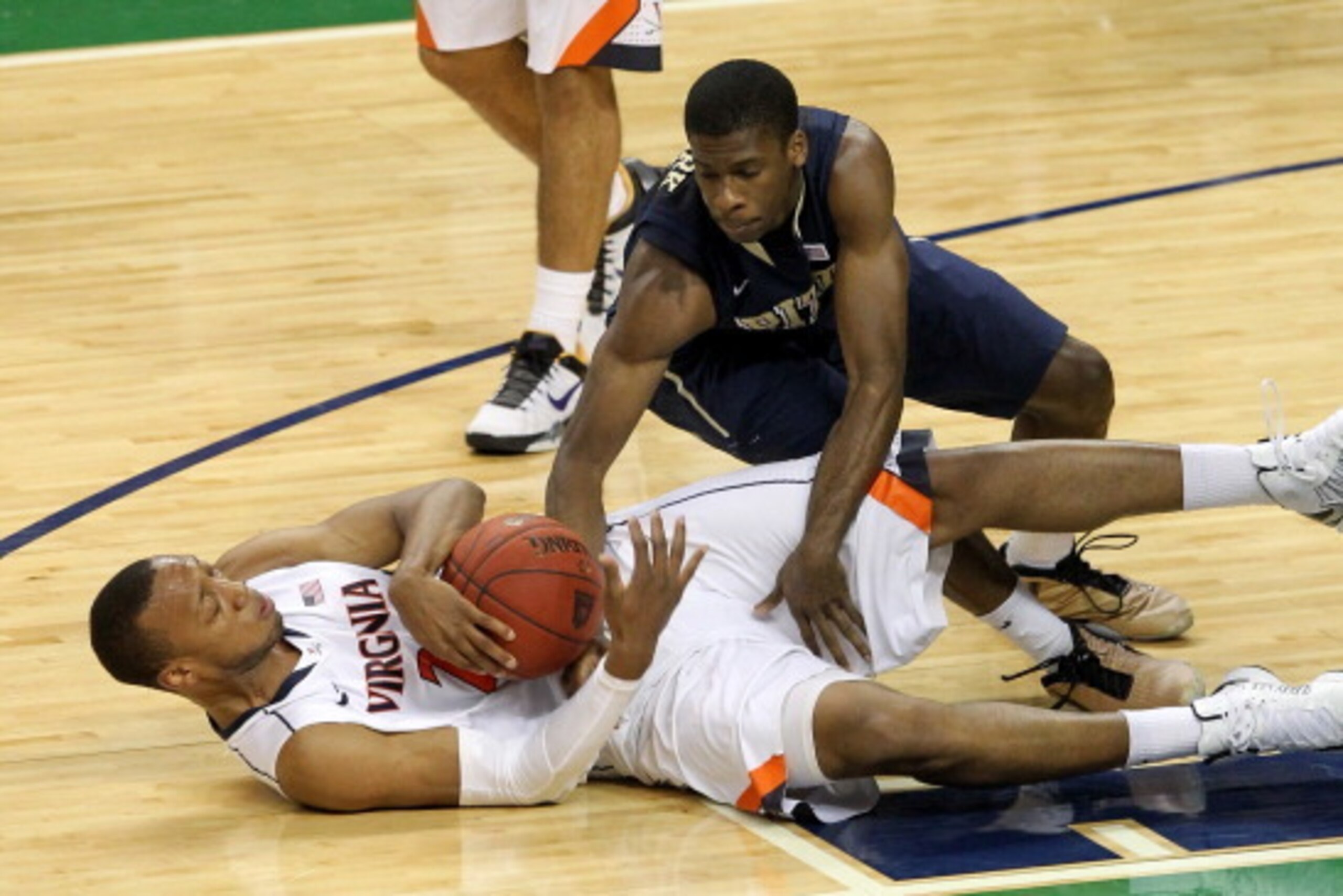 GREENSBORO, NC - MARCH 15: Josh Newkirk #13 of the Pittsburgh Panthers and Akil Mitchell #25 of the Virginia Cavaliers battle for a loose ball during the semifinals of the 2014 Men's ACC Basketball Tournament at Greensboro Coliseum on March 15, 2014 in G GREENSBORO, NC - MARCH 15: Josh Newkirk #13 of the Pittsburgh Panthers and Akil Mitchell #25 of the Virginia Cavaliers battle for a loose ball during the semifinals of the 2014 Men's ACC Basketball Tournament at Greensboro Coliseum on March 15, 2014 in G