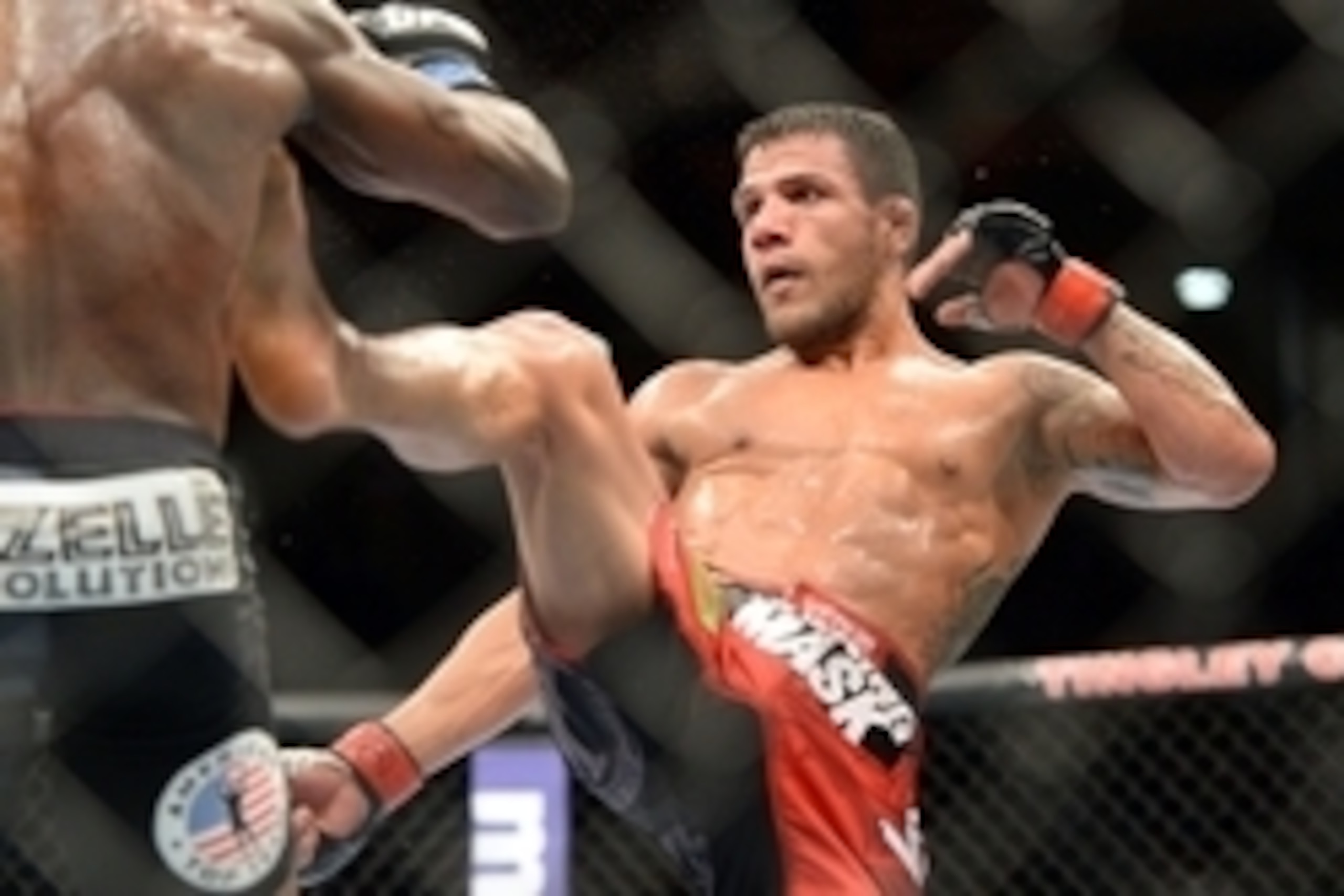 Jun 7, 2014; Albuquerque, NM, USA; Rafael Dos Anjos (red) and Jason High (blue) fight during their lightweight bout during UFC Fight Night 42 at Tingley Coliseum. Dos Anjos won via second round stoppage. Mandatory Credit: Joe Camporeale-USA TODAY Sports