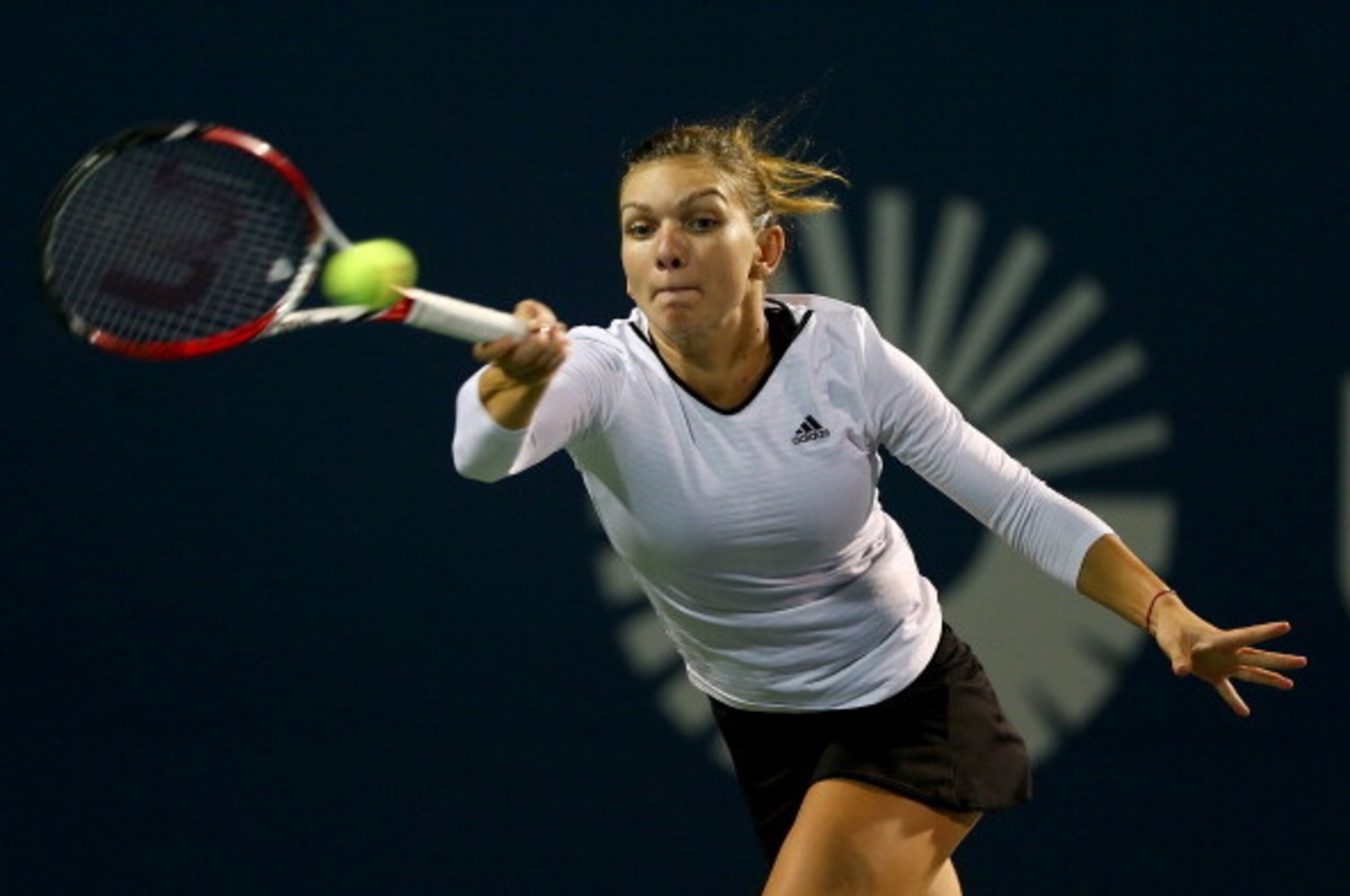 NEW HAVEN, CT - AUGUST 19:  Simona Halep of Romania returns a shot to Magdalena Rybarikova of Slovakia during the Connecticut Open at the Connecticut Tennis Center at Yale on August 19, 2014 in New Haven, Connecticut.  (Photo by Elsa/Getty Images)