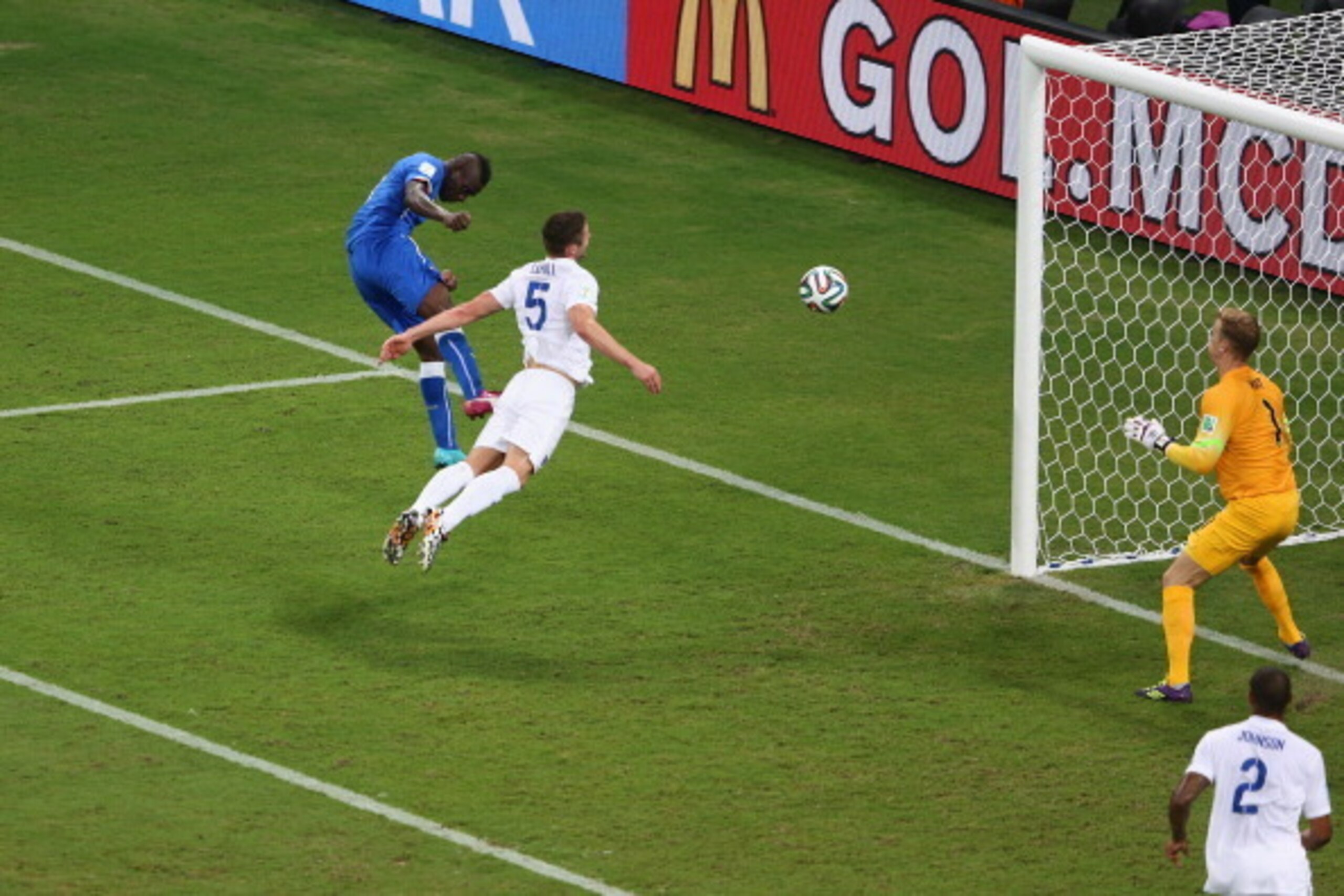 MANAUS, BRAZIL - JUNE 14: Mario Balotelli of Italy scores his team's second goal on a header past Gary Cahill and goalkeeper Joe Hart of England during the 2014 FIFA World Cup Brazil Group D match between England and Italy at Arena Amazonia on June 14, 2 MANAUS, BRAZIL - JUNE 14: Mario Balotelli of Italy scores his team's second goal on a header past Gary Cahill and goalkeeper Joe Hart of England during the 2014 FIFA World Cup Brazil Group D match between England and Italy at Arena Amazonia on June 14, 2