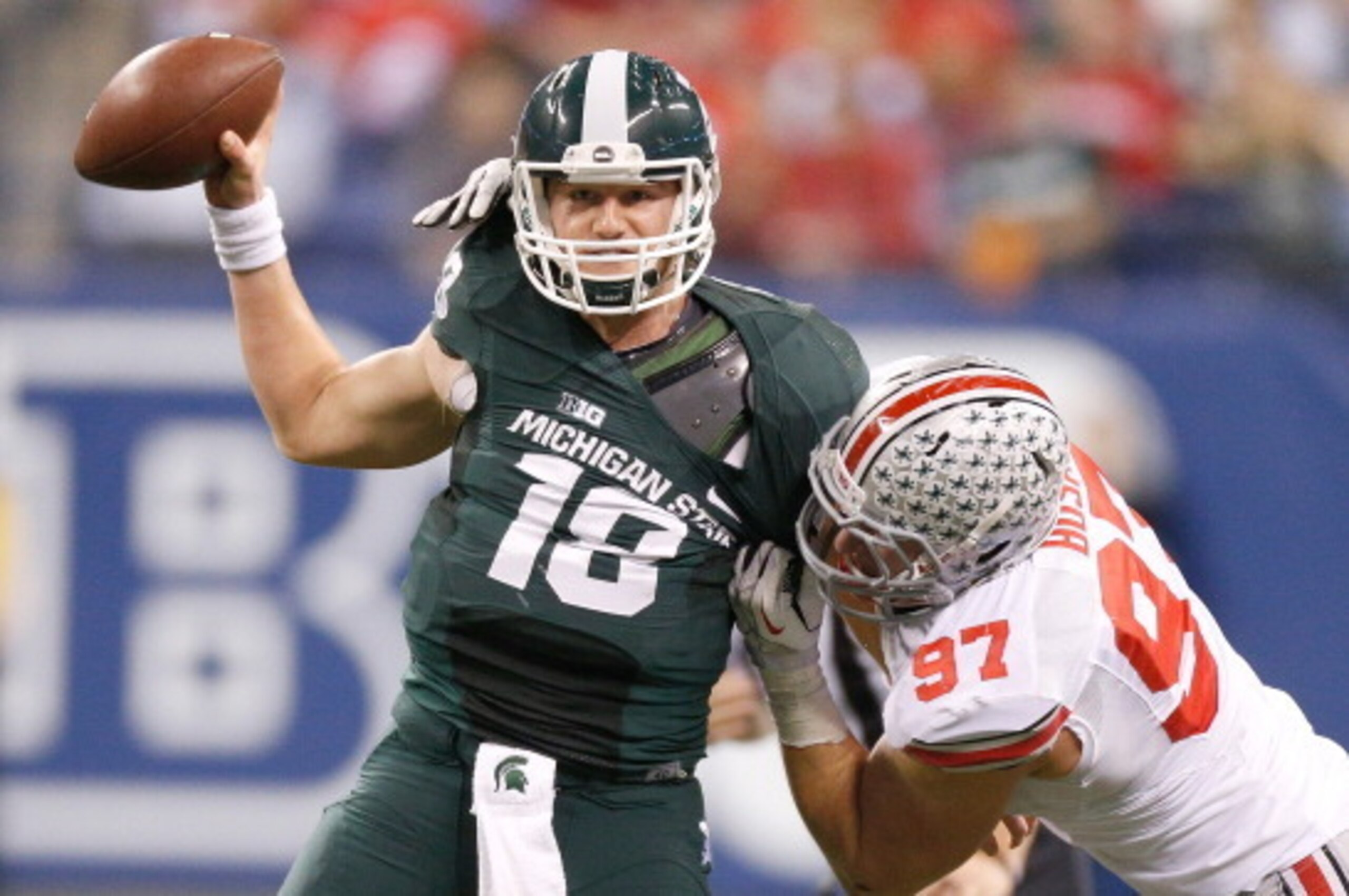 INDIANAPOLIS, IN - DECEMBER 07: Joey Bosa #97 of the Ohio State Buckeyes drags down Connor Cook #18 of the Michigan State Spartans in the third quarter during the Big 10 Conference Championship Game at Lucas Oil Stadium on December 7, 2013 in Indianapolis