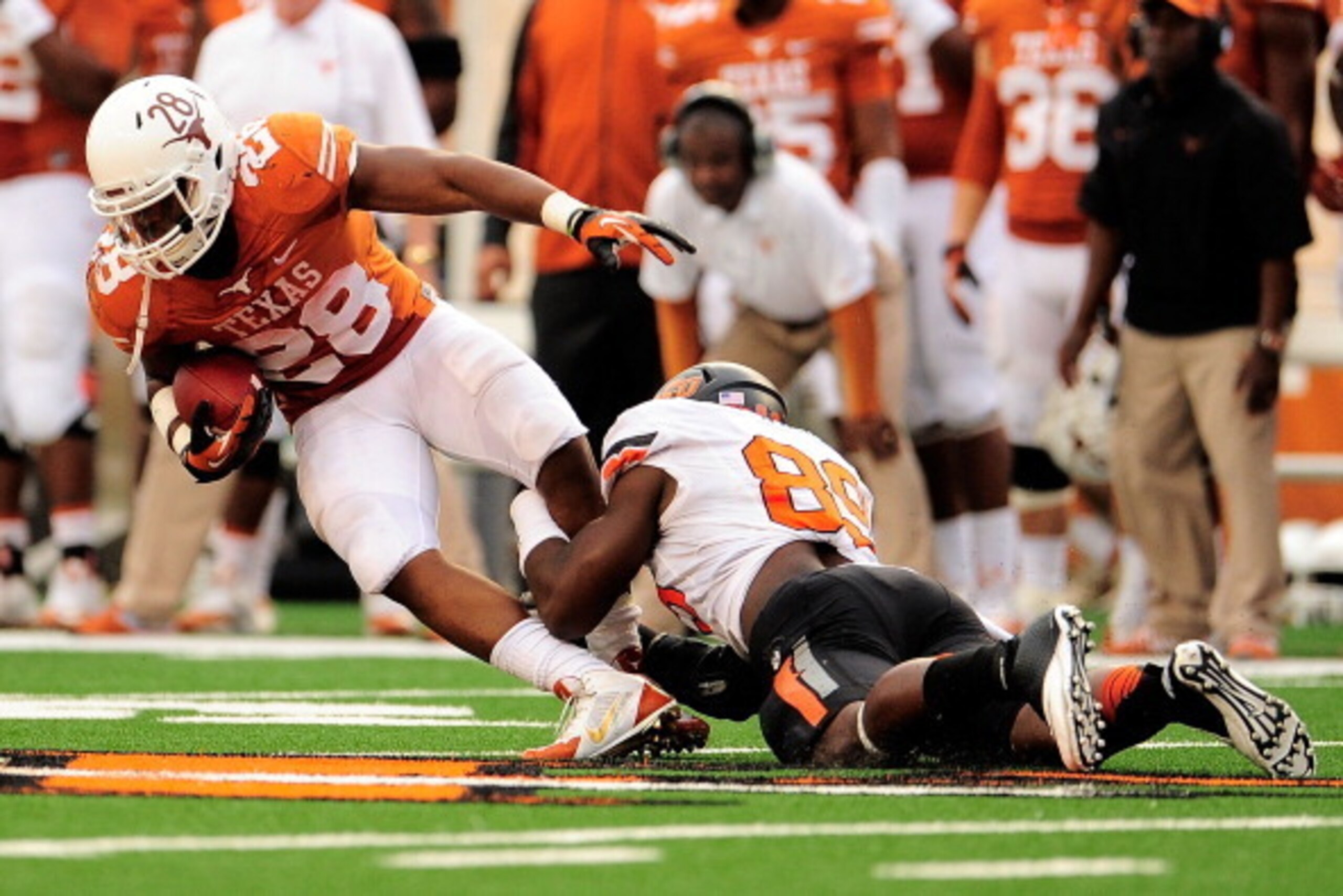 AUSTIN, TX - NOVEMBER 16: Sam Wren #89 of the Oklahoma State Cowboys tackles Malcolm Brown #28 of the Texas Longhorns during a game at Darrell K Royal-Texas Memorial Stadium on November 16, 2013 in Austin, Texas. Oklahoma State won the game 38-13. (Pho AUSTIN, TX - NOVEMBER 16: Sam Wren #89 of the Oklahoma State Cowboys tackles Malcolm Brown #28 of the Texas Longhorns during a game at Darrell K Royal-Texas Memorial Stadium on November 16, 2013 in Austin, Texas. Oklahoma State won the game 38-13. (Pho