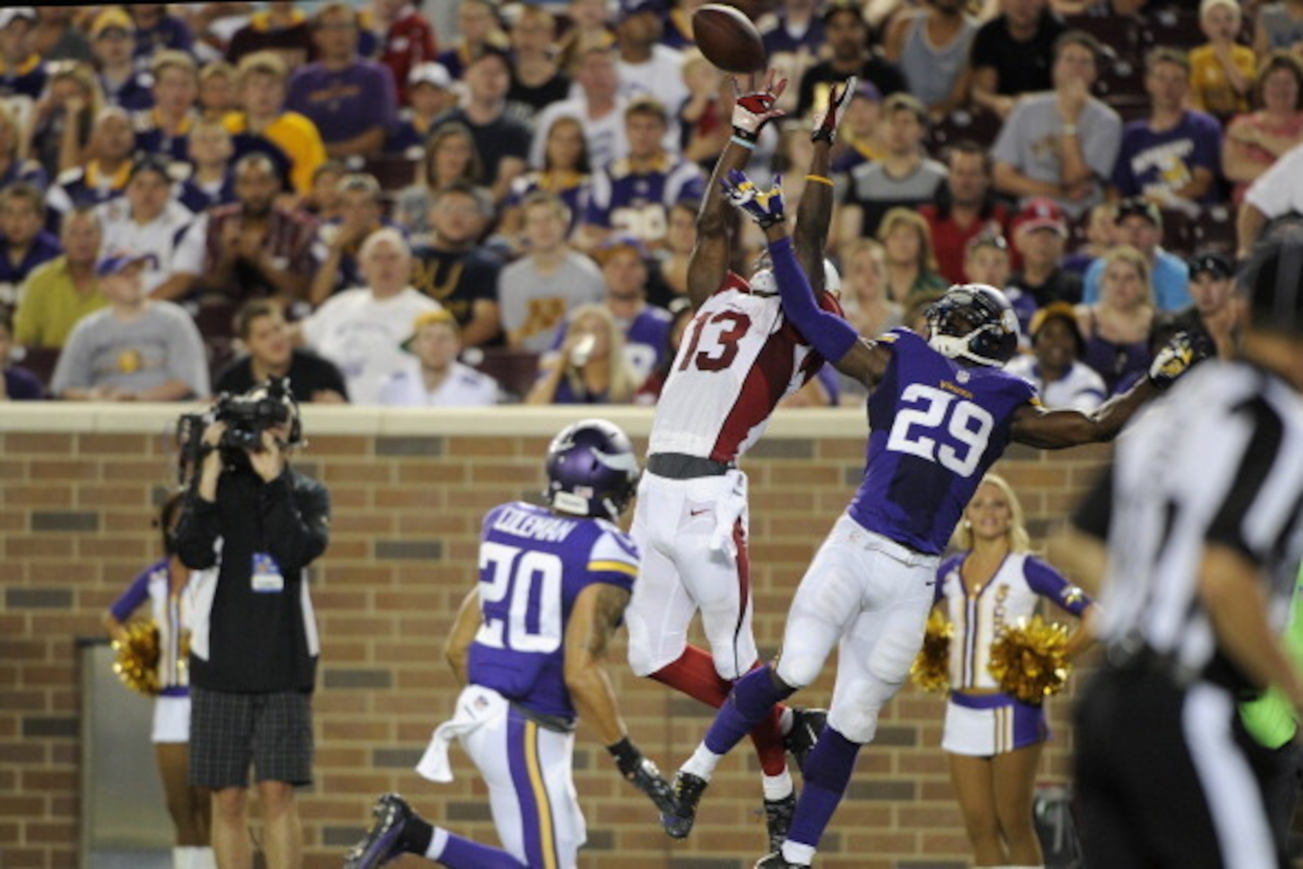 MINNEAPOLIS, MN - AUGUST 16: Jaron Brown #13 of the Arizona Cardinals catches a pass against Kurt Coleman #20 and Xavier Rhodes #29 of the Minnesota Vikings during the second quarter of the preseason game on August 16, 2014 at TCF Bank Stadium in Minneapo