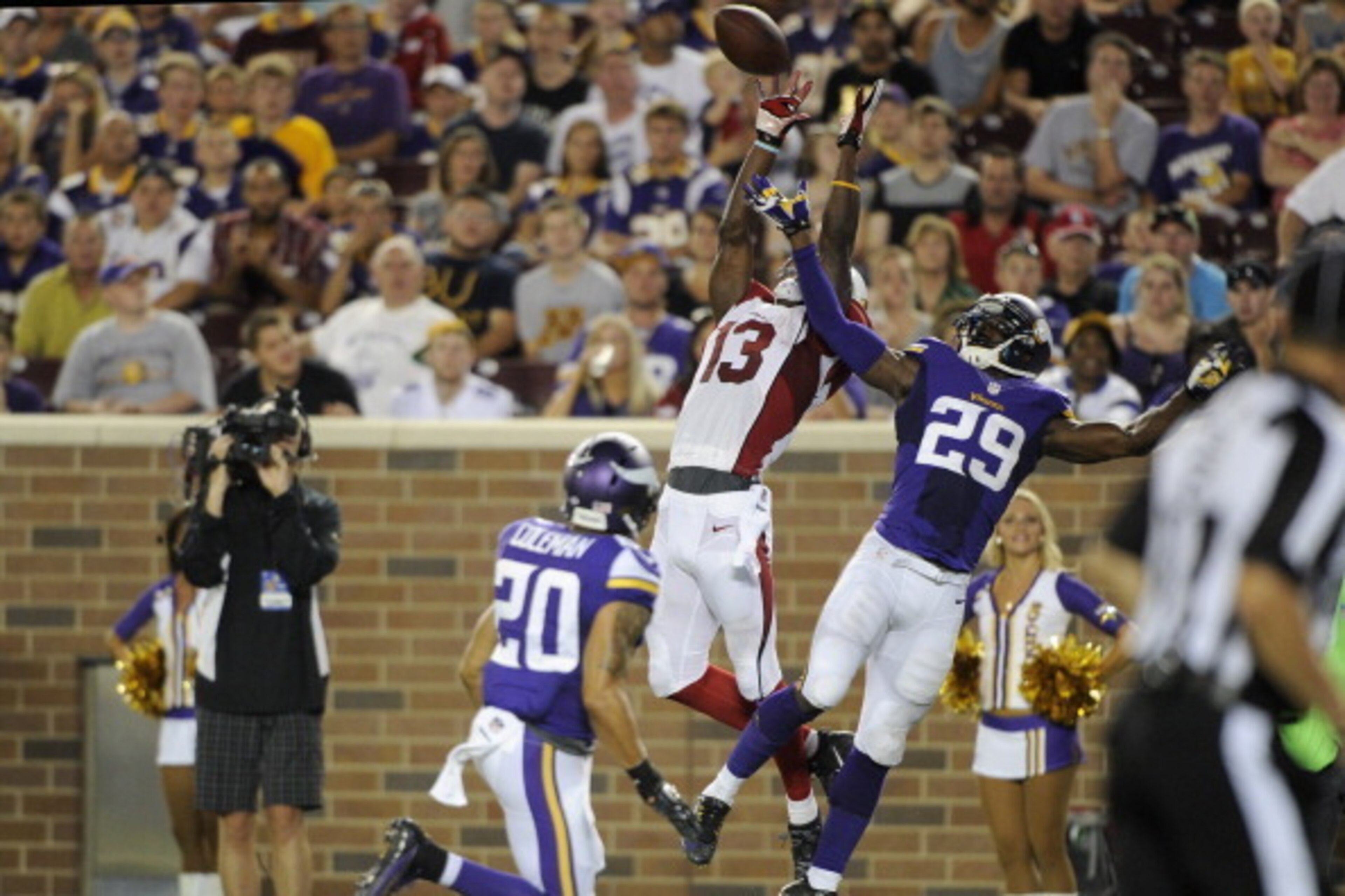 MINNEAPOLIS, MN - AUGUST 16: Jaron Brown #13 of the Arizona Cardinals catches a pass against Kurt Coleman #20 and Xavier Rhodes #29 of the Minnesota Vikings during the second quarter of the preseason game on August 16, 2014 at TCF Bank Stadium in Minneapo