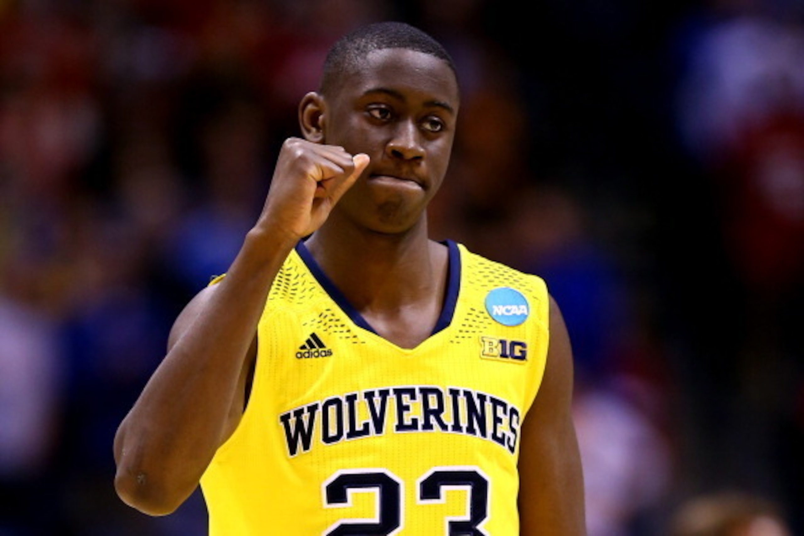 INDIANAPOLIS, IN - MARCH 28:  Caris LeVert #23 of the Michigan Wolverines celebrates defeating the Tennessee Volunteers 73 to 71 during the regional semifinal of the 2014 NCAA Men's Basketball Tournament at Lucas Oil Stadium on March 28, 2014 in Indianapo