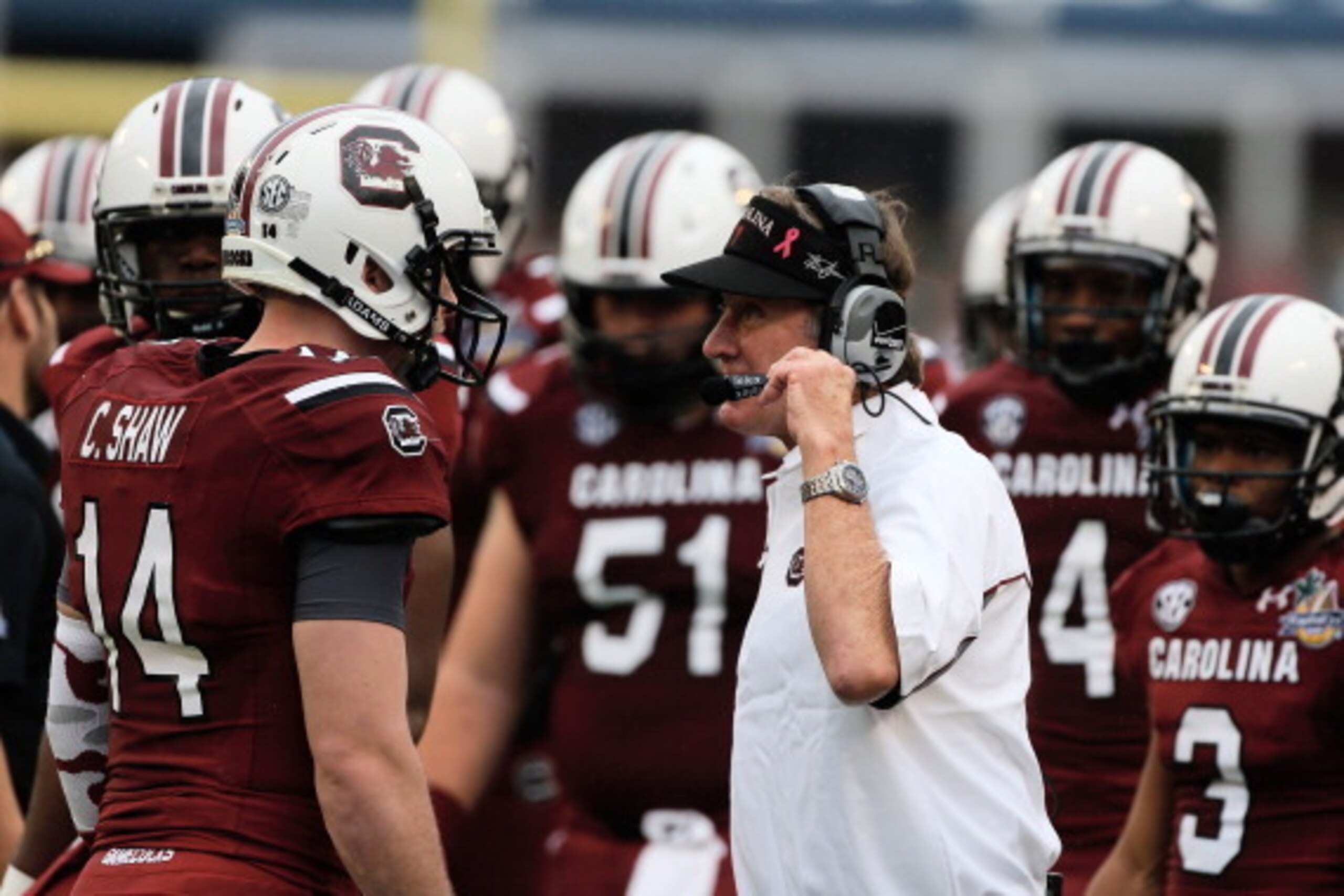 ORLANDO, FL - JANUARY 01:  Head coach Steve Spurrier of the South Carolina Gamecocks chats with his quarterback Connor Shaw #14 in the first half of their game against the Wisconsin Badgers at the Capital One Bowl on January 1, 2014 in Orlando, Florida.  