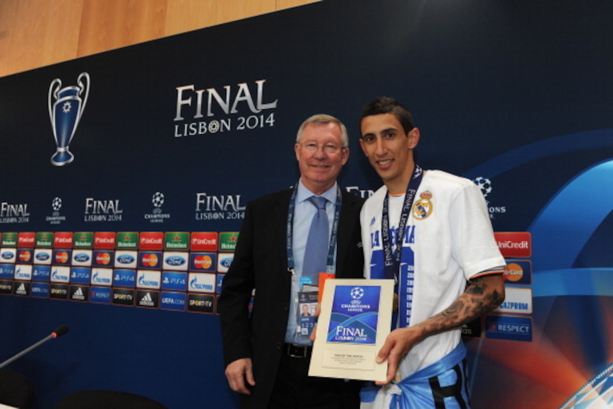 LISBON, PORTUGAL - MAY 24:  In this handout image provided by UEFA, Sir Alex Ferguson poses with Real Madrids Angel Di Maria after presenting him with the Man Of The Match award during the post match press conference after the UEFA Champions League final 