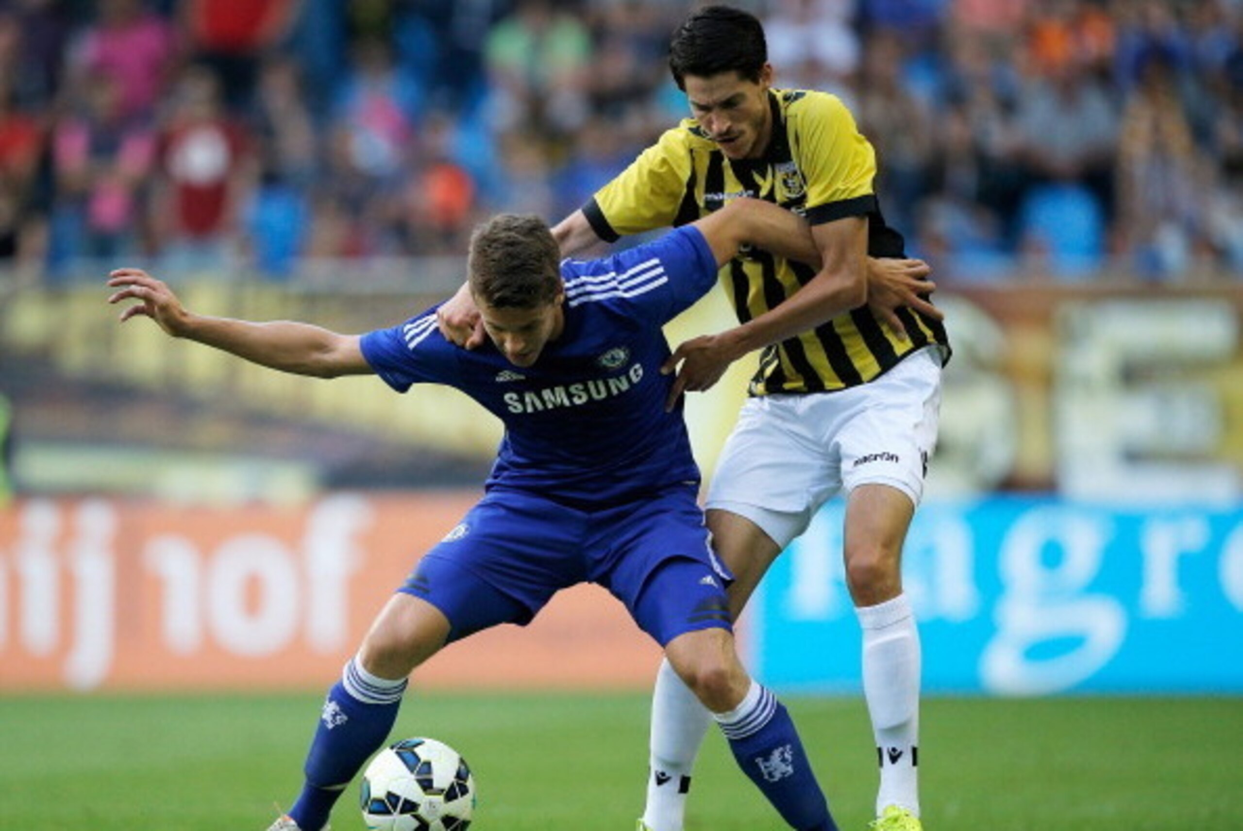 ARNHEM, NETHERLANDS - JULY 30:  Marko Vejinovic of Vitesse and Marco van Ginkel of Chelsea battle for the ball during the pre season friendly match between Vitesse Arnhem and Chelsea at the Gelredome Stadium on July 30, 2014 in Arnhem, Netherlands.  (Phot