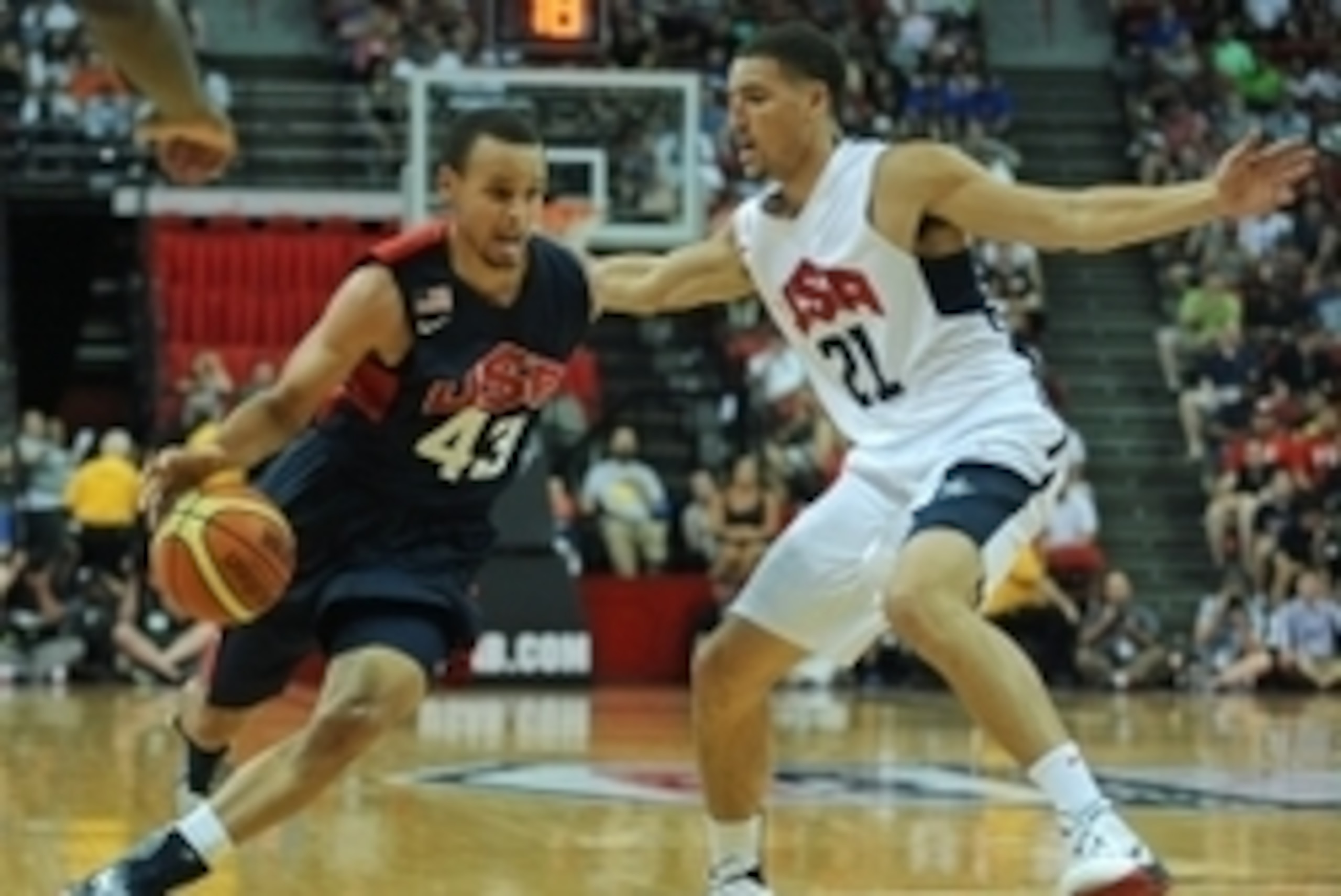 Aug 1, 2014; Las Vegas, NV, USA; USA Team Blue guard Stephen Curry (43) dribbles the ball into the lane against the defense of USA Team White guard Klay Thompson (21) during the USA Basketball Showcase at Thomas & Mack Center. Mandatory Credit: Stephen R.
