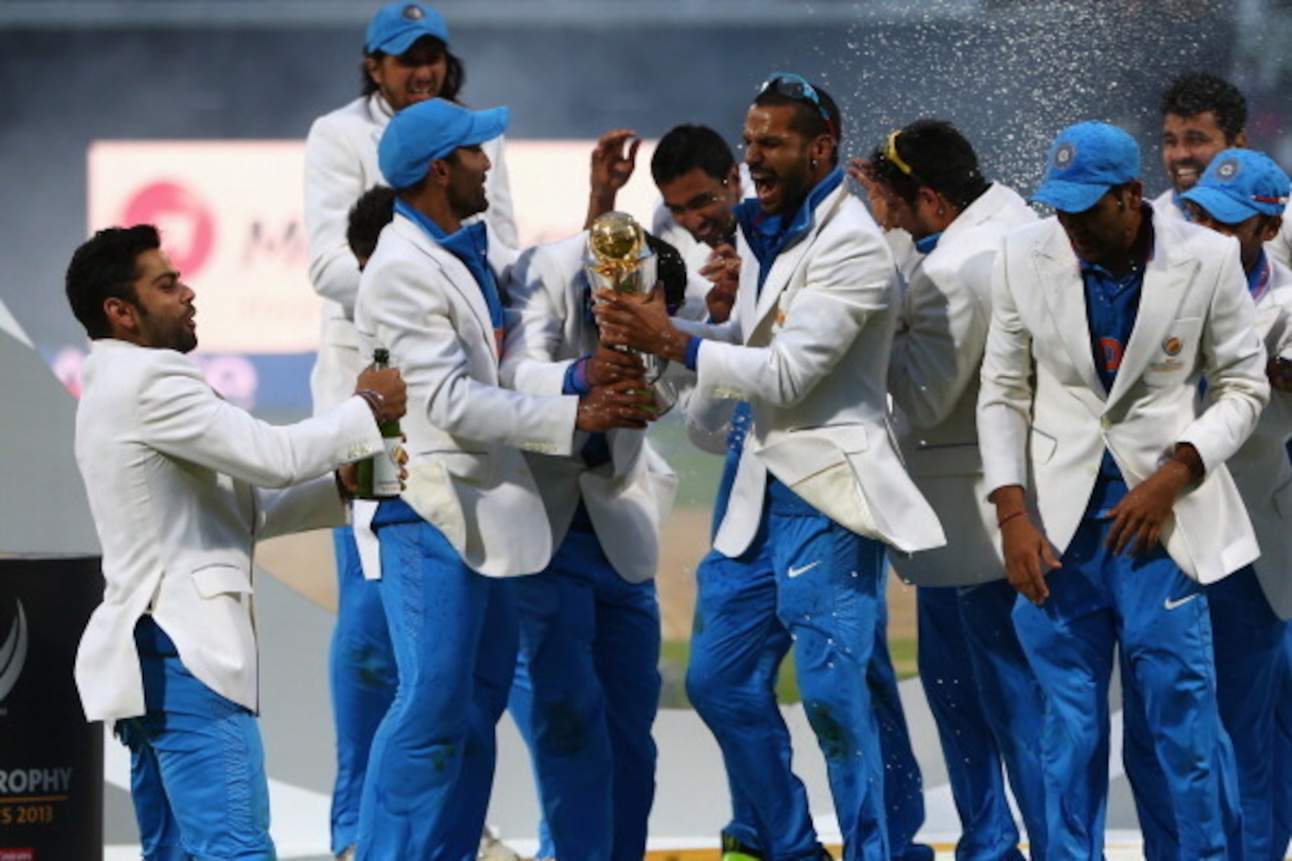 BIRMINGHAM, ENGLAND - JUNE 23:  The India squad lift the winners trophy as they celebrate their 5 run victory during the ICC Champions Trophy Final match between England and India at Edgbaston on June 23, 2013 in Birmingham, England.  (Photo by Michael St