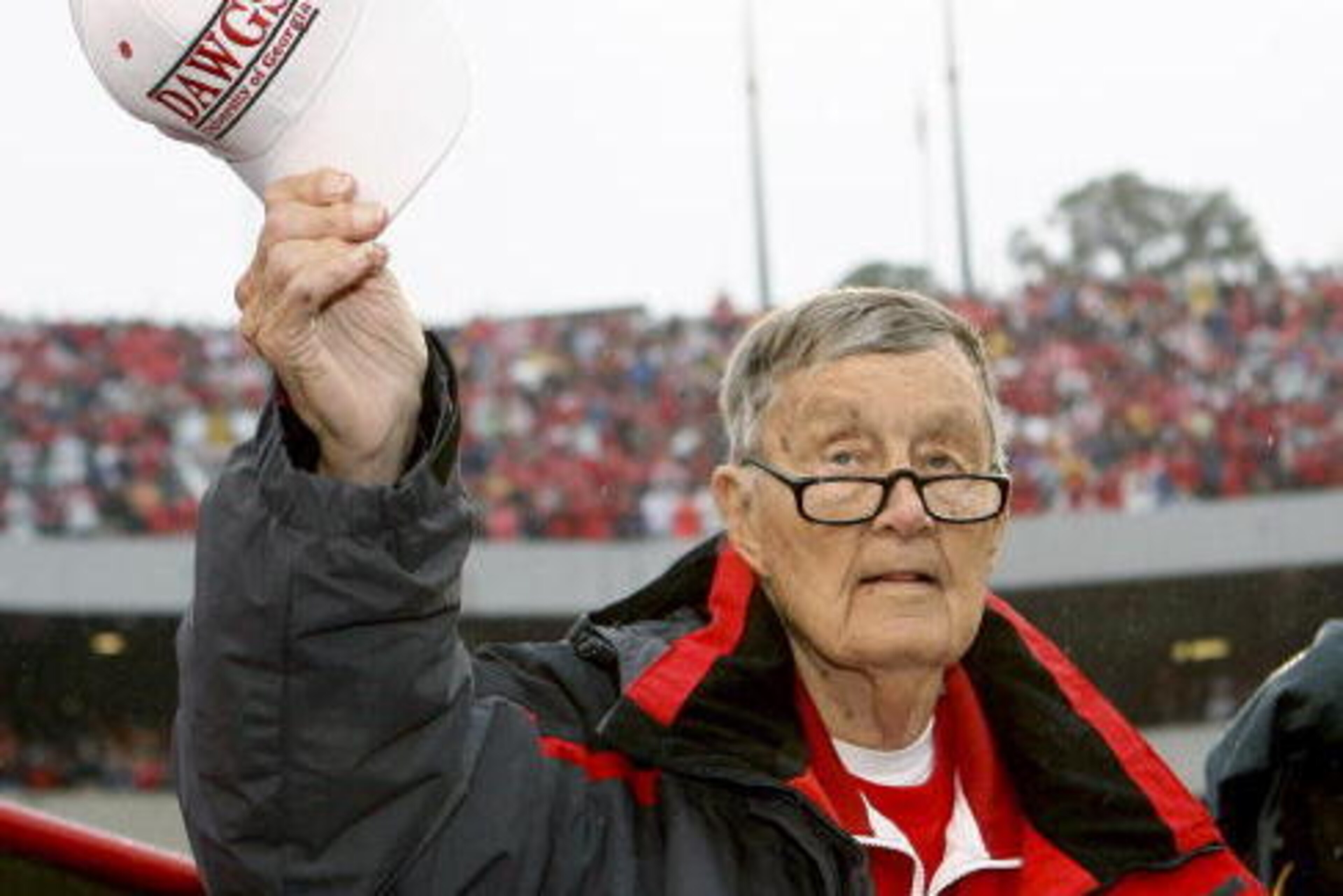 ATHENS, GA - NOVEMBER 29:  Former long-time Georgia Bulldogs radio announcer Larry Munson acknowledges the crowd during a tribute to him after the first quarter of the game against the Georgia Tech Yellow Jackets at Sanford Stadium on November 29, 2008 in