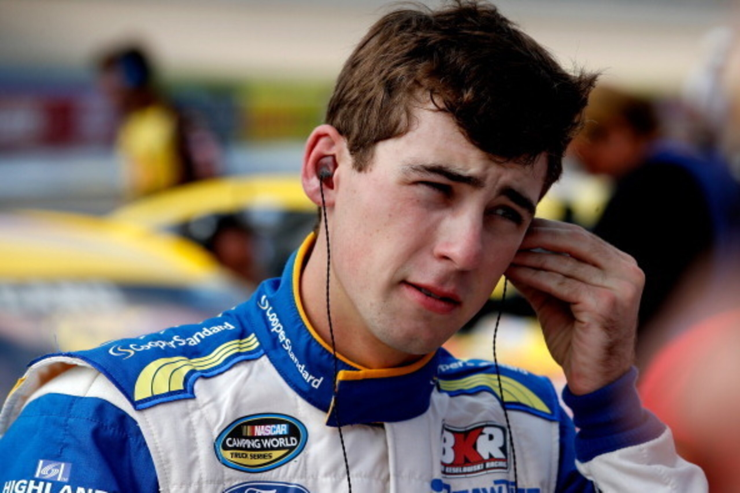 BROOKLYN, MI - AUGUST 15: Ryan Blaney, driver of the #21 Motorcraft/Quick Lane Tire & Auto Center Ford, stands on the grid during qualifying for the NASCAR Sprint Cup Series Pure Michigan 400 at Michigan International Speedway on August 15, 2014 in Brookl