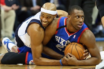 DALLAS, TX - NOVEMBER 18:  (L-R) Vince Carter #25 of the Dallas Mavericks and Thaddeus Young #21 of the Philadelphia 76ers hold on to the ball on a jump ball call at American Airlines Center on November 18, 2013 in Dallas, Texas.  NOTE TO USER: User expre