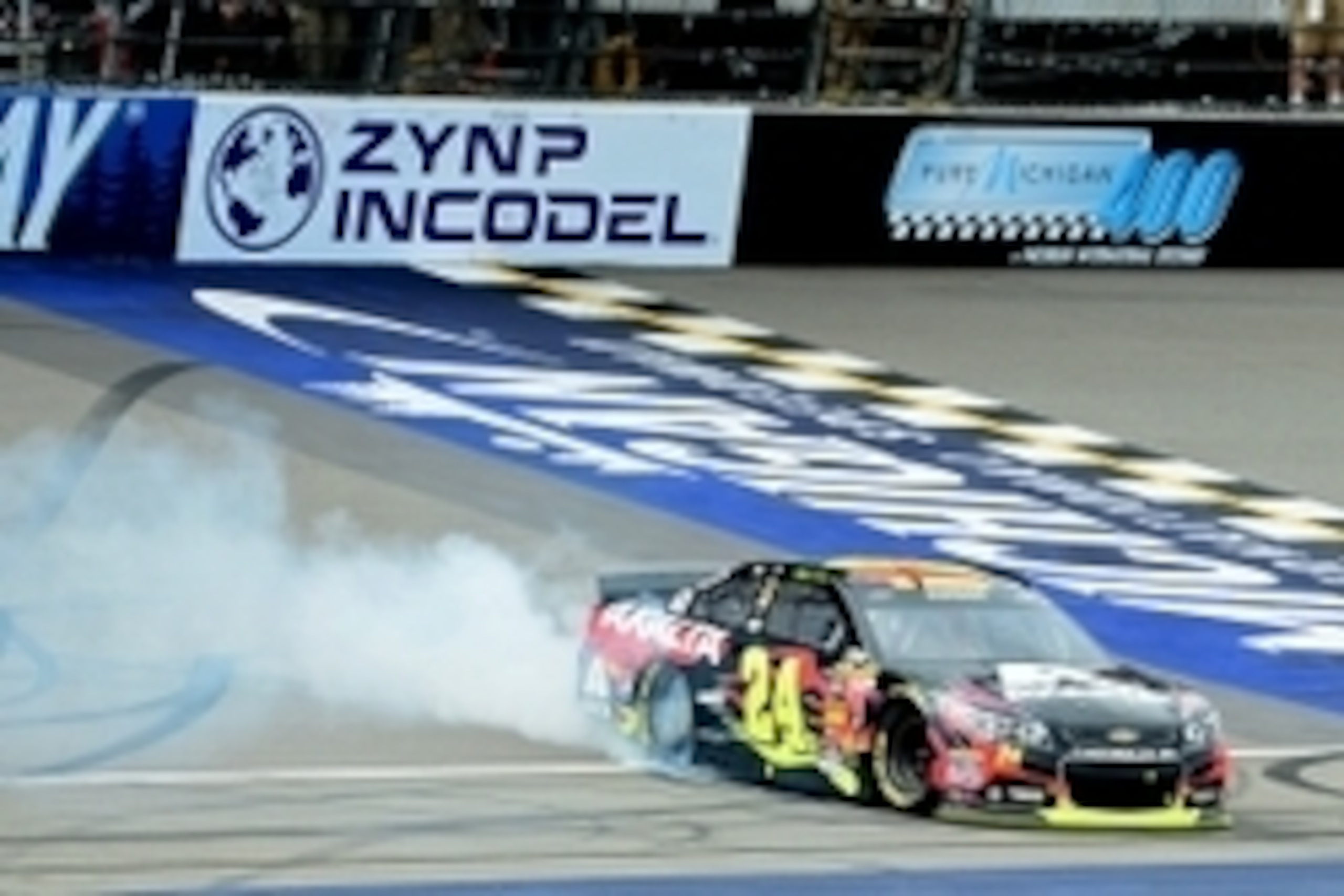 Aug 17, 2014; Brooklyn, MI, USA; NASCAR Sprint Cup Series driver Jeff Gordon burns out after winning the Pure Michigan 400 at Michigan International Speedway. Mandatory Credit: Andrew Weber-USA TODAY Sports
