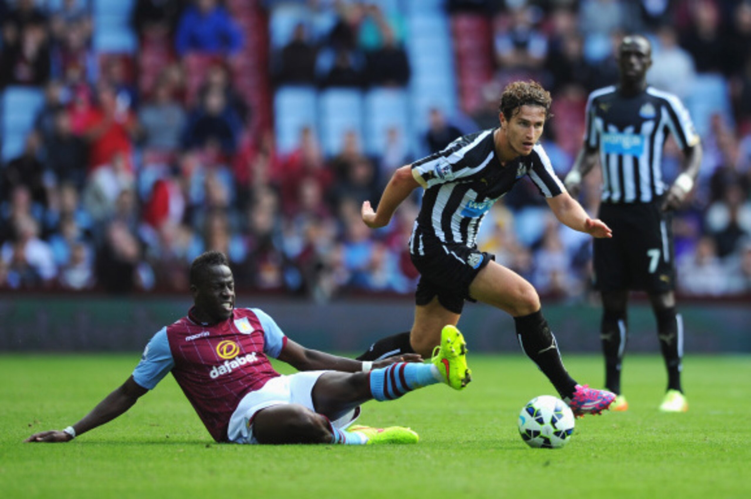 BIRMINGHAM, ENGLAND - AUGUST 23:  Daryl Janmaat of Newcastle United is tackled by Aly Cissokho of Aston Villa during the Barclays Premier League match between Aston Villa and Newcastle United at Villa Park on August 23, 2014 in Birmingham, England.  (Phot