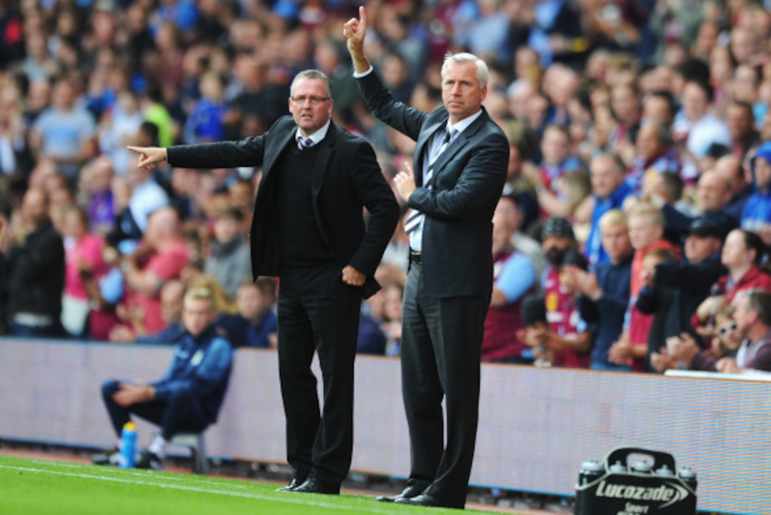 BIRMINGHAM, ENGLAND - AUGUST 23: Manager Paul Lambert (L) of Aston Villa gives instructions with Alan Pardew, manager of Newcastle United during the Barclays Premier League match between Aston Villa and Newcastle United at Villa Park on August 23, 2014 in