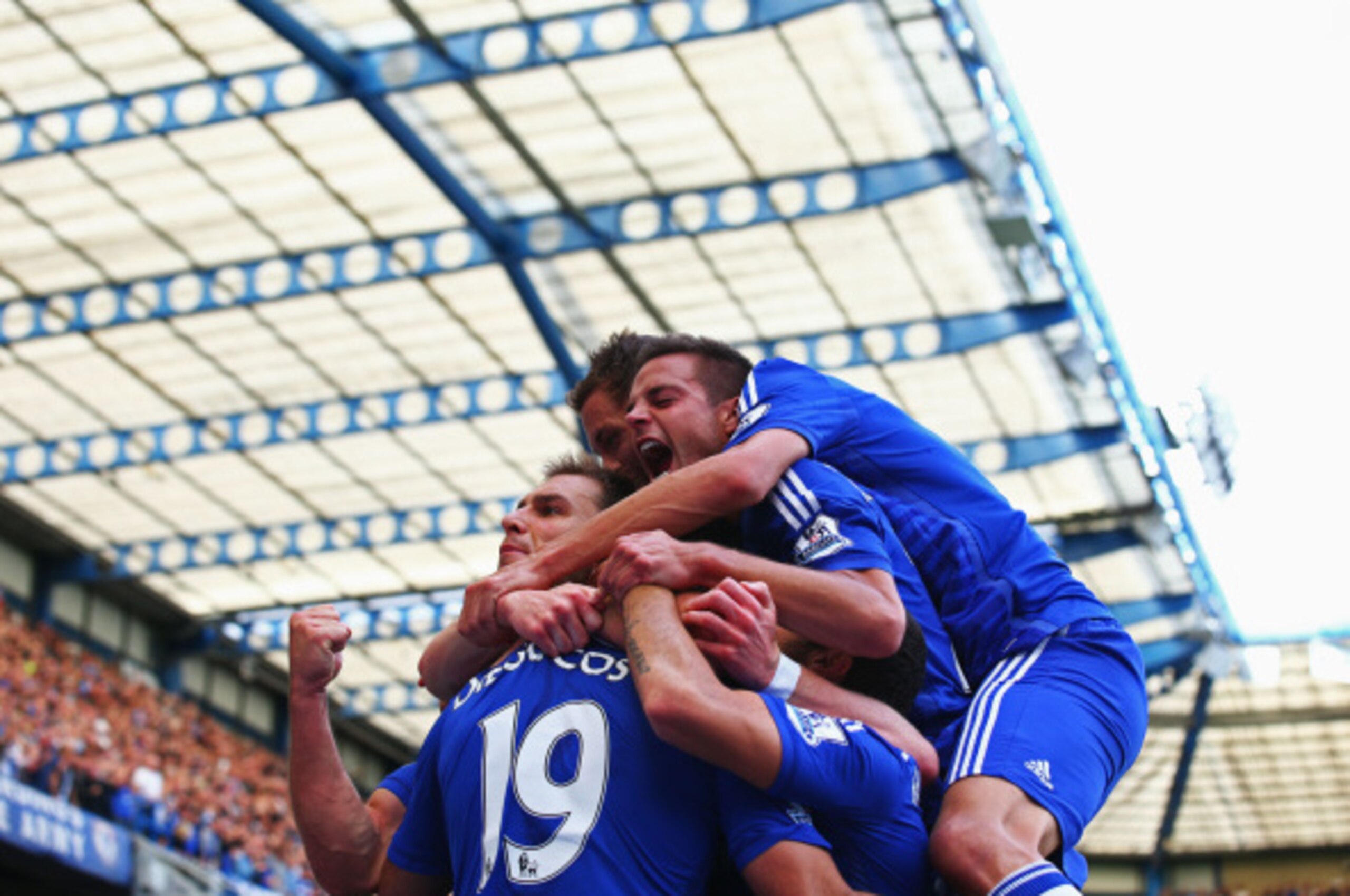 LONDON, ENGLAND - AUGUST 23:  Diego Costa of Chelsea is mobbed by team mates after scoring their first goal during the Barclays Premier League match between Chelsea and Leicester City at Stamford Bridge on August 23, 2014 in London, England.  (Photo by Pa