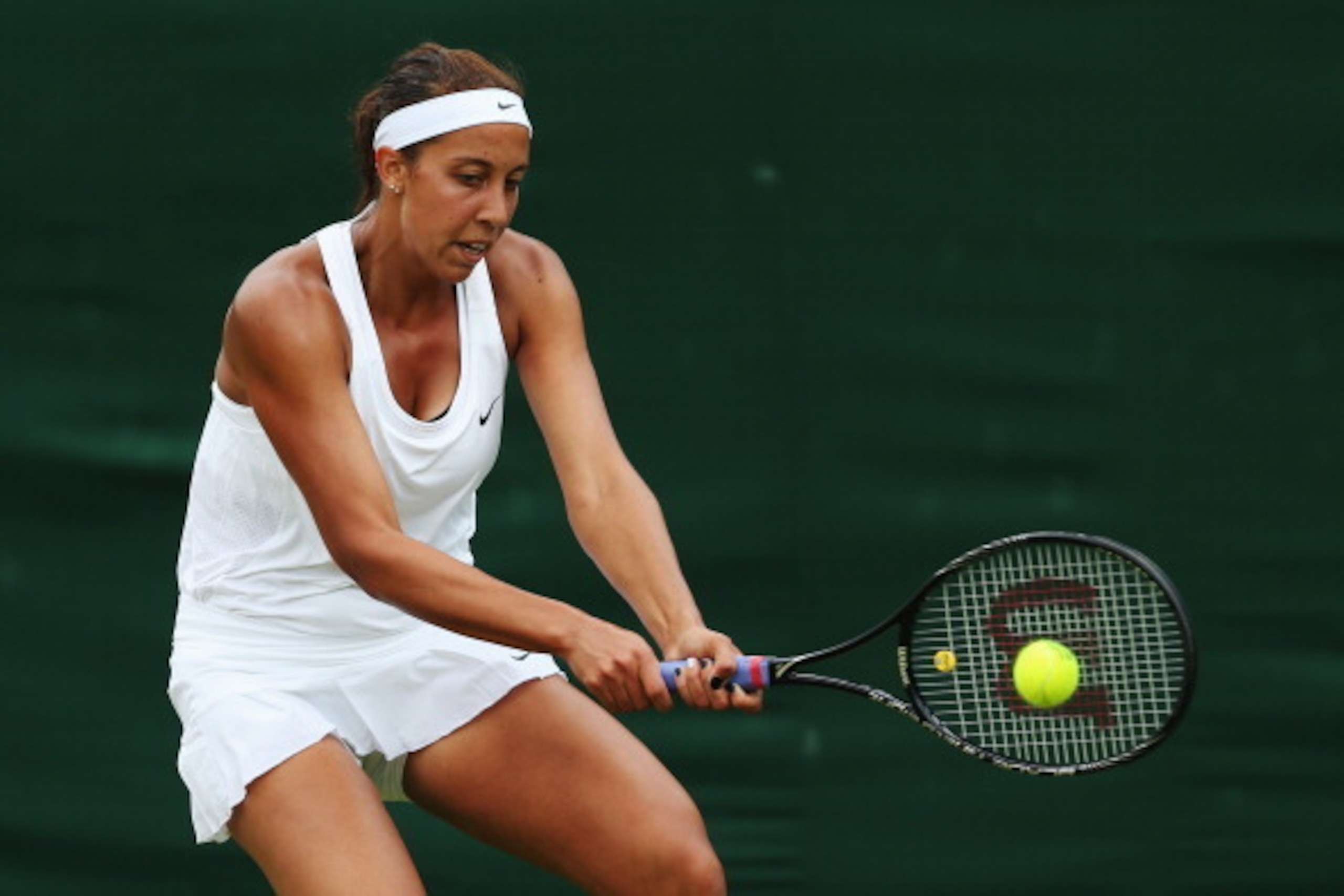 LONDON, ENGLAND - JUNE 24:  Madison Keys of the United States plays a backhand during her Ladies' Singles first round match against against Monica Puig of Puerto Rico on day two of the Wimbledon Lawn Tennis Championships at the All England Lawn Tennis and