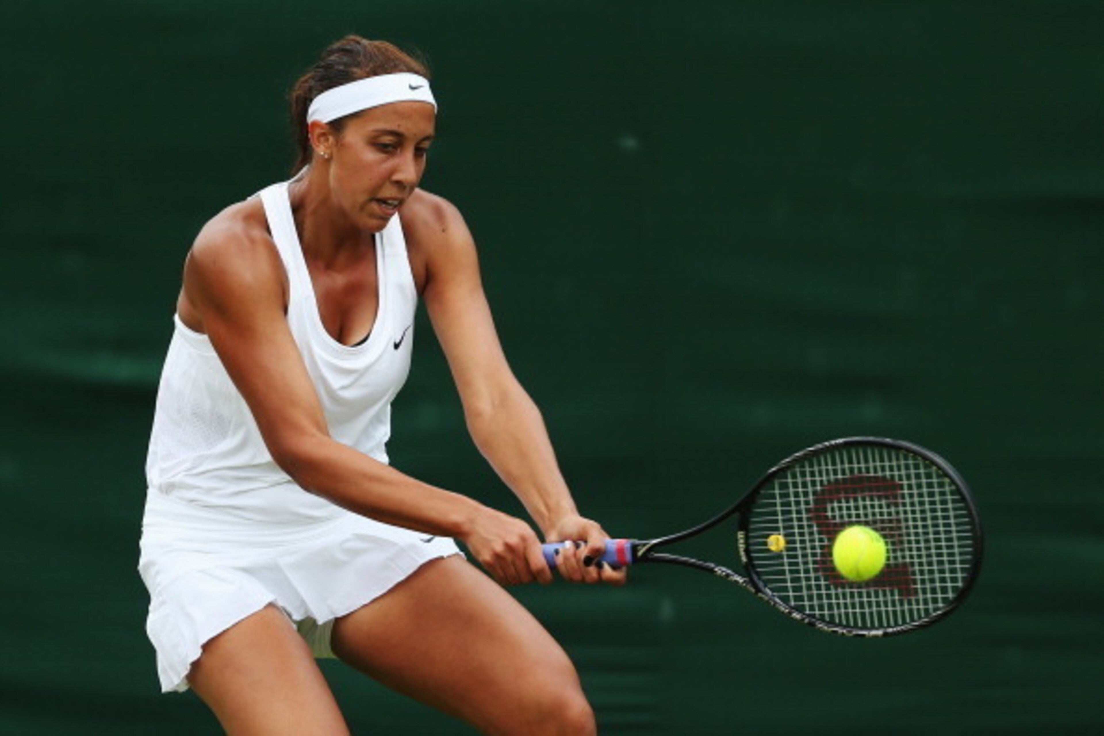 LONDON, ENGLAND - JUNE 24:  Madison Keys of the United States plays a backhand during her Ladies' Singles first round match against against Monica Puig of Puerto Rico on day two of the Wimbledon Lawn Tennis Championships at the All England Lawn Tennis and