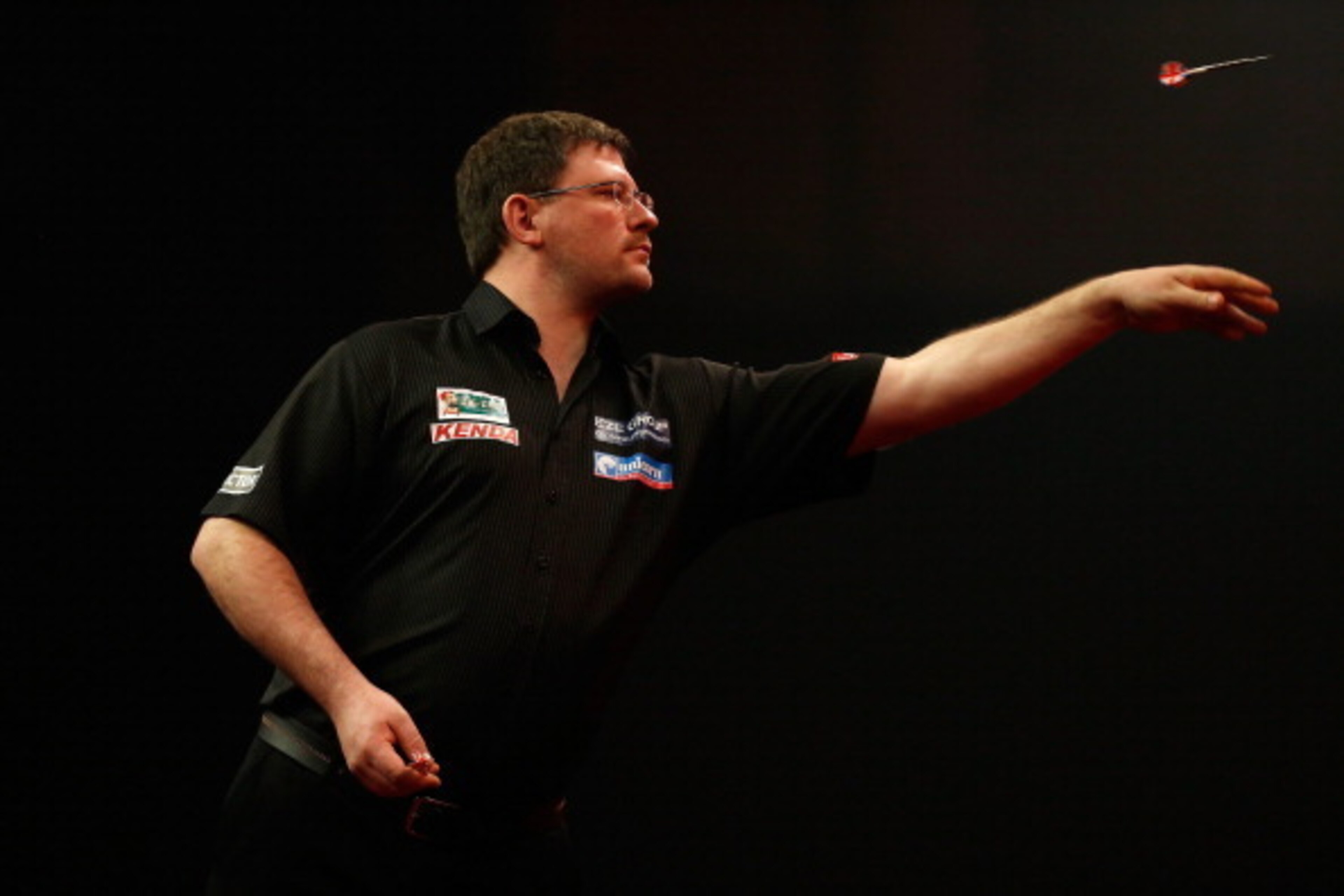 LONDON, ENGLAND - DECEMBER 28:  James Wade of England in action during his third round match against Devon Petersen of South Africa on day thirteen of the Ladbrokes.com World Darts Championship at Alexandra Palace on December 28, 2013 in London, England. 