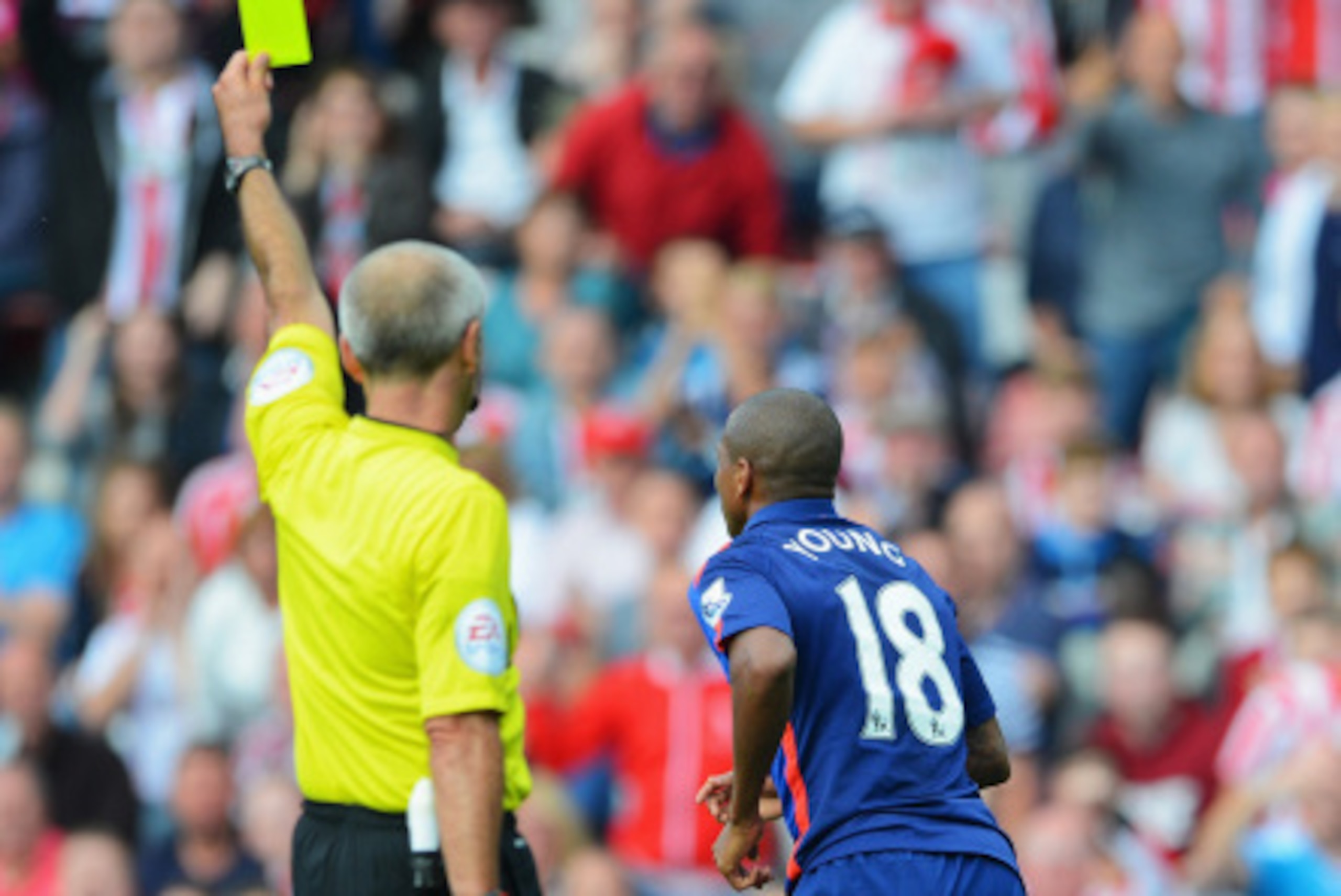 SUNDERLAND, ENGLAND - AUGUST 24: Referee Martin Atkinson shows the yellow card to Ashley Young of Manchester United for diving during the Barclays Premier League match between Sunderland and Manchester United at Stadium of Light on August 24, 2014 in Sund