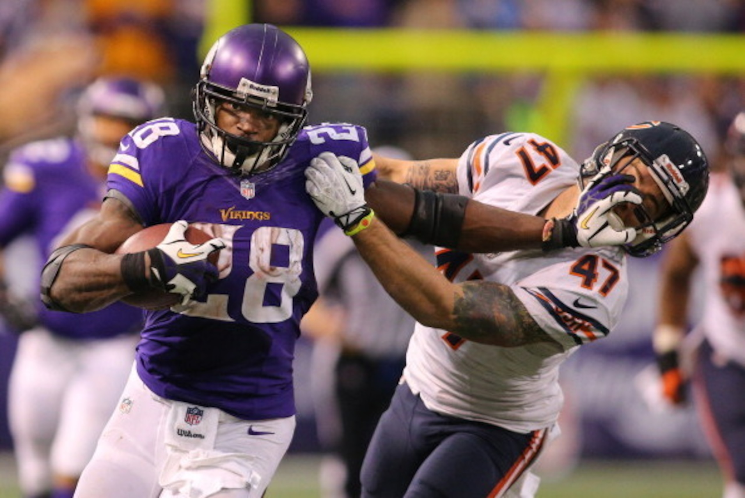 MINNEAPOLIS, MN - DECEMBER 1: Adrian Peterson #28 of the Minnesota Vikings carries the ball for ten thousand career rushing yards against Chris Conte #47 of the Chicago Bears on December 1, 2013 at Mall of America Field at the Hubert Humphrey Metrodome i MINNEAPOLIS, MN - DECEMBER 1: Adrian Peterson #28 of the Minnesota Vikings carries the ball for ten thousand career rushing yards against Chris Conte #47 of the Chicago Bears on December 1, 2013 at Mall of America Field at the Hubert Humphrey Metrodome i