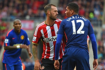 SUNDERLAND, ENGLAND - AUGUST 24: Steven Fletcher of Sunderland confronts Chris Smalling of Manchester United during the Barclays Premier League match between Sunderland and Manchester United at Stadium of Light on August 24, 2014 in Sunderland, England.  