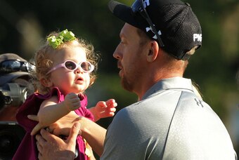 PARAMUS, NJ - AUGUST 24:  Hunter Mahan holds his daughter Zoe celebrates as he celebrates finishing on the 18th green during the final round of The Barclays at The Ridgewood Country Club on August 24, 2014 in Paramus, New Jersey.  (Photo by Hunter Martin/