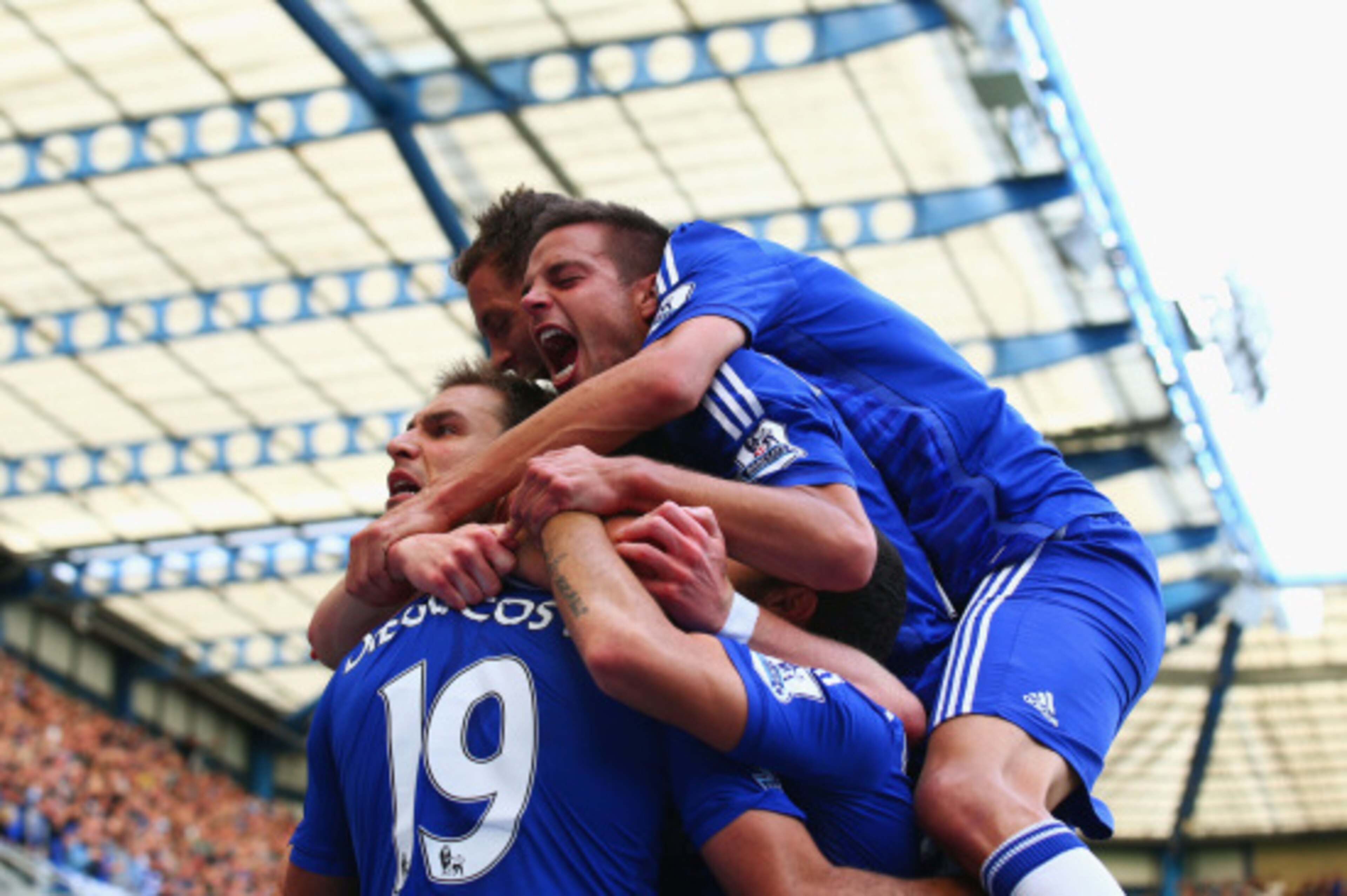 LONDON, ENGLAND - AUGUST 23:  Diego Costa of Chelsea is mobbed by team mates after scoring their first goal during the Barclays Premier League match between Chelsea and Leicester City at Stamford Bridge on August 23, 2014 in London, England.  (Photo by Pa