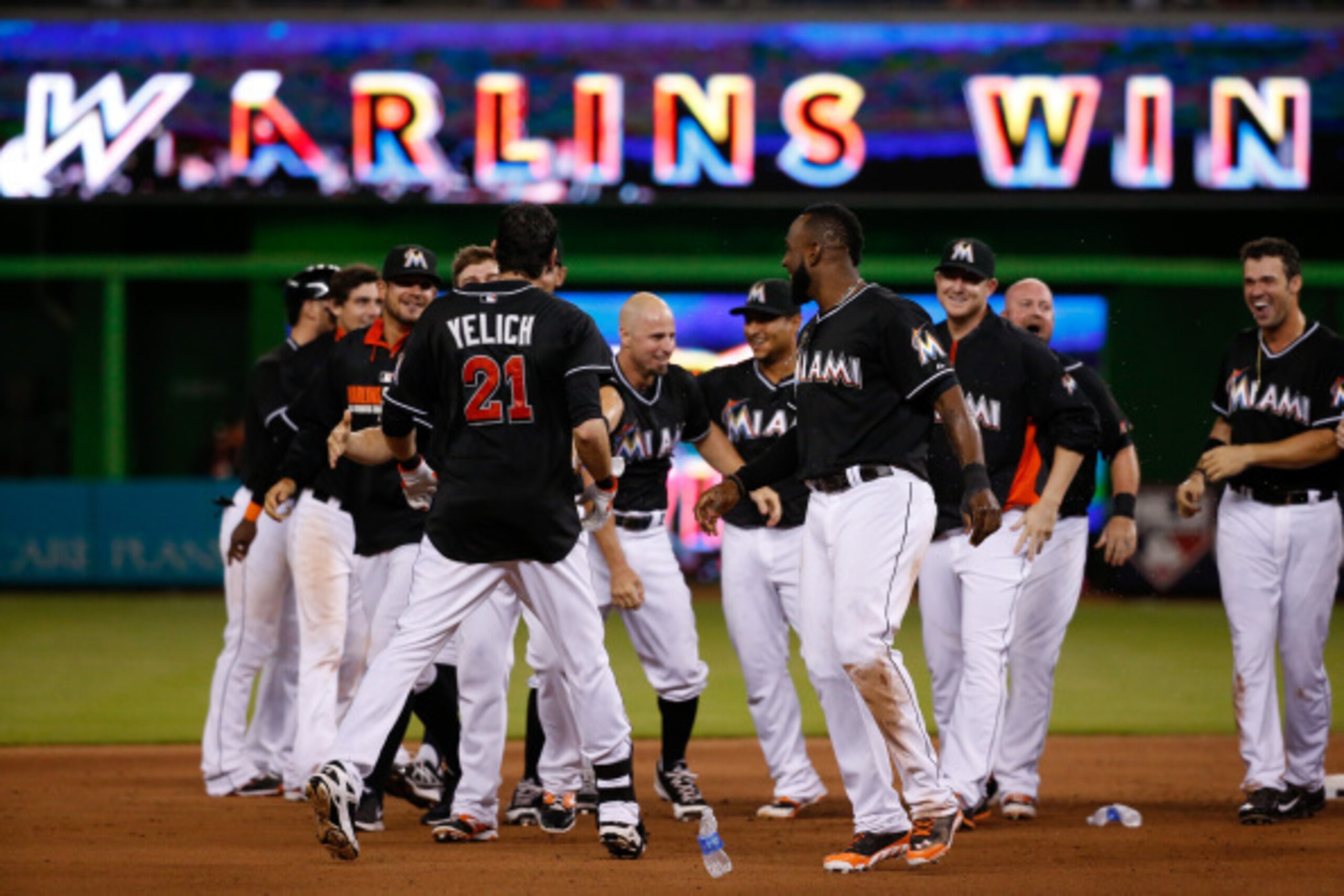 MIAMI, FL - AUGUST 02: Christian Yelich #21 of the Miami Marlins reacts with teammates after hitting a walk-off single to win the game against the Cincinnati Reds in ten innings at Marlins Park on August 02, 2014 in Miami, Florida.  (Photo by Rob Foldy/Ge