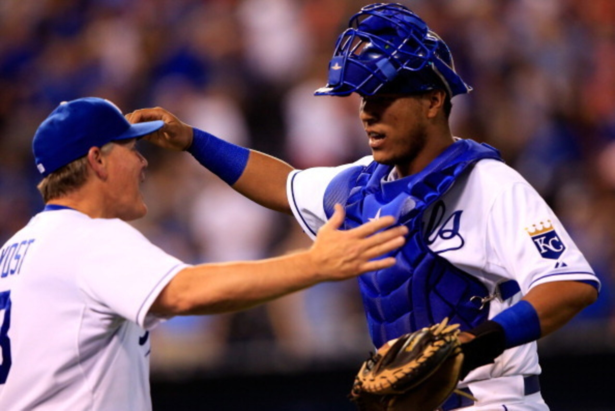 KANSAS CITY, MO - AUGUST 08:  Salvador Perez #13 of the Kansas City Royals is congratulated by manager Ned Yost #3  as the Royals defeat the San Francisco Giants 4-2 to win the game at Kauffman Stadium on August 8, 2014 in Kansas City, Missouri.  (Photo b