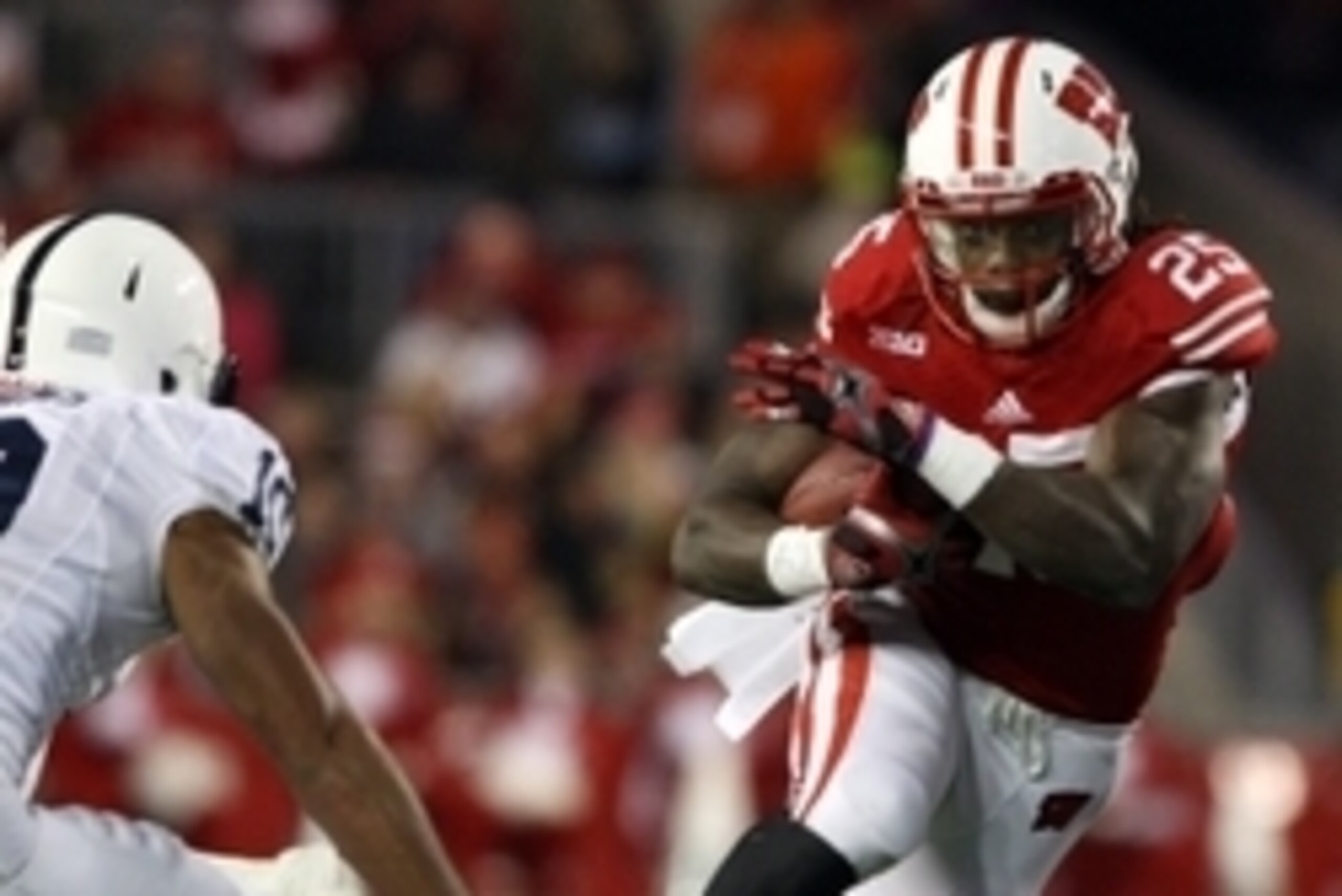 Nov 30, 2013; Madison, WI, USA; Wisconsin Badgers running back Melvin Gordon (25) rushes for yardage as Penn State Nittany Lions cornerback Trevor Williams (10) defends  at Camp Randall Stadium. Penn State defeated Wisconsin 31-24. Mandatory Credit: Mary 