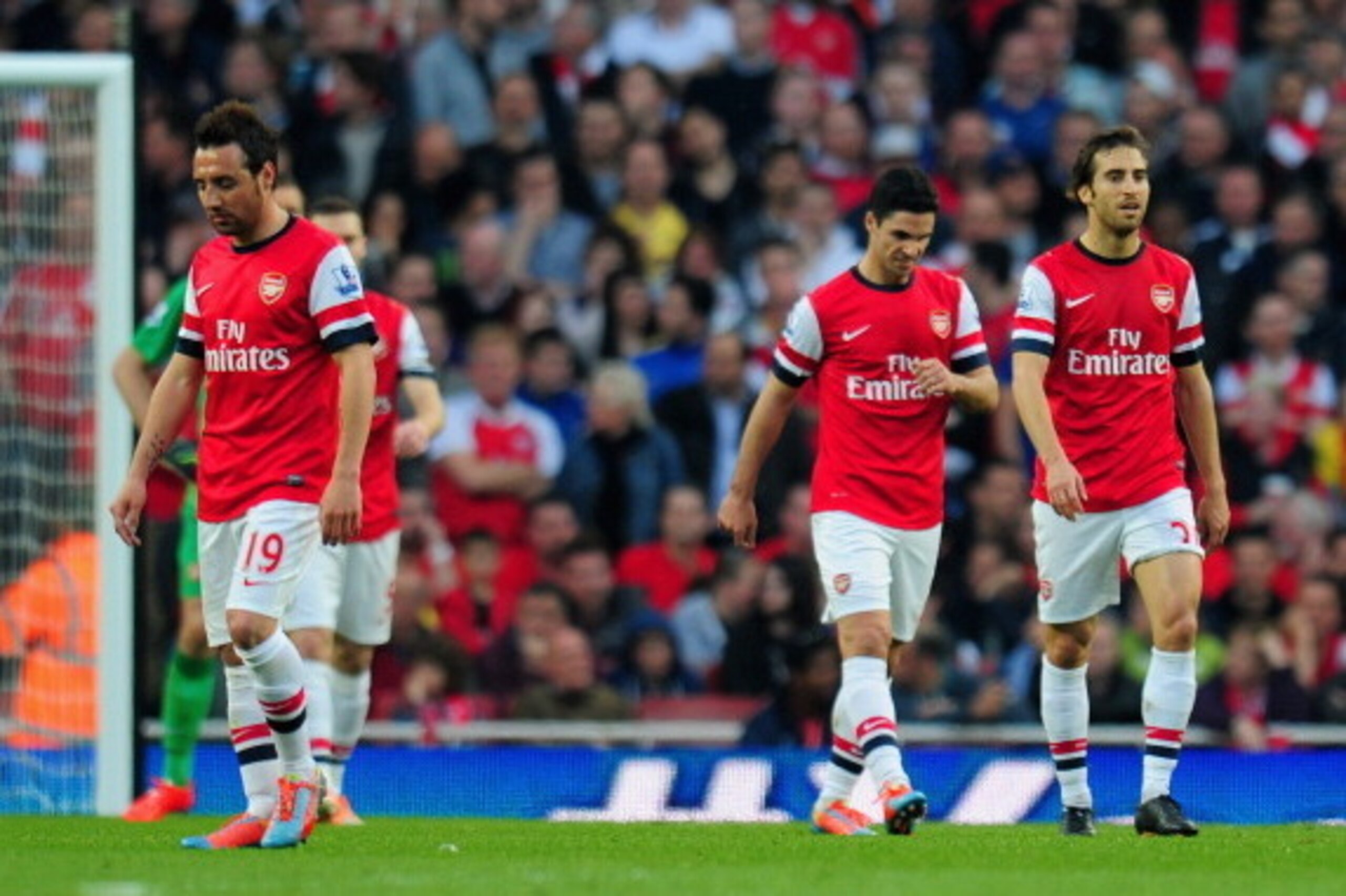 LONDON, ENGLAND - MARCH 29:  A dejected Santi Cazorla, Mikel Arteta and Mathieu Flamini of Arsenal after conceding the first goal during the Barclays Premier League match between Arsenal and Manchester City at Emirates Stadium on March 29, 2014 in London,