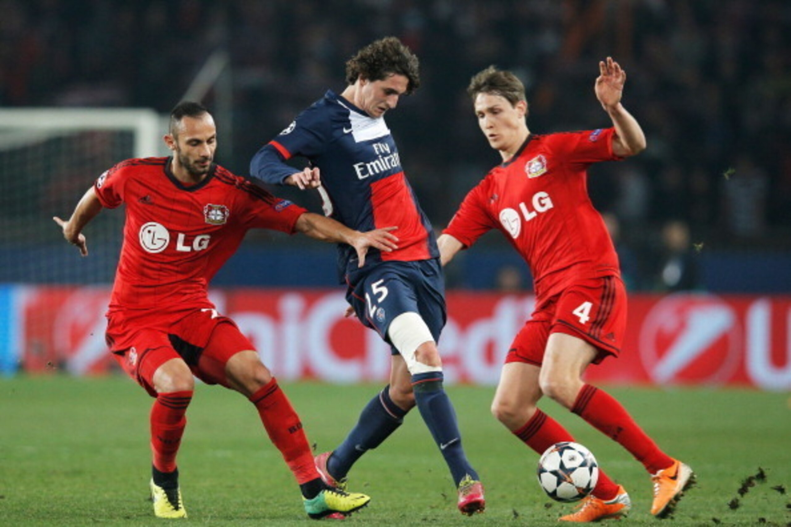 PARIS, FRANCE - MARCH 12: Adrien Rabiot of Paris Saint-Germain (C) battles with Omer Toprak (L) and Philipp Wollscheid of Bayer Leverkusen (R) during the UEFA Champions League Round of 16 second leg match between Paris Saint-Germain FC and Bayer Leverkus PARIS, FRANCE - MARCH 12: Adrien Rabiot of Paris Saint-Germain (C) battles with Omer Toprak (L) and Philipp Wollscheid of Bayer Leverkusen (R) during the UEFA Champions League Round of 16 second leg match between Paris Saint-Germain FC and Bayer Leverkus
