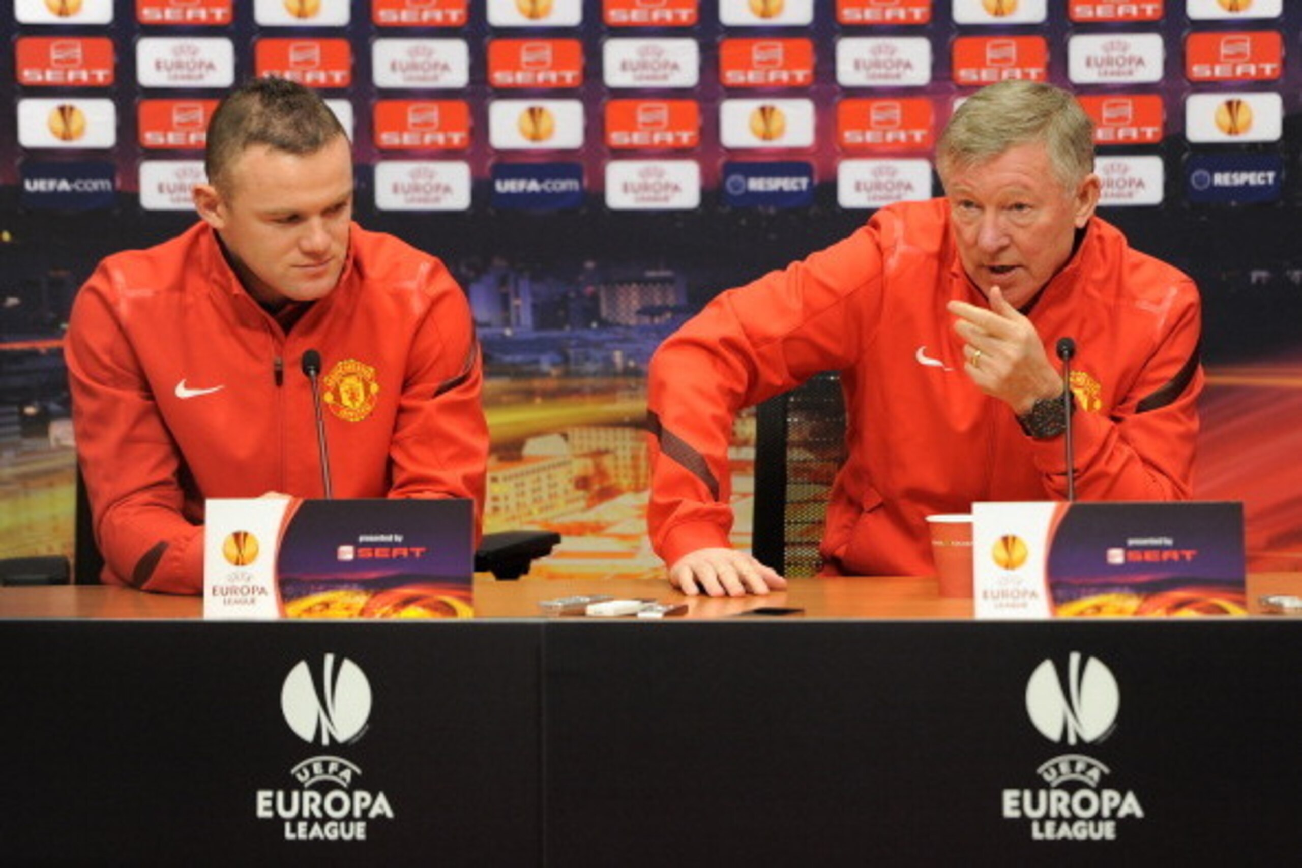 AMSTERDAM, NETHERLANDS - FEBRUARY 15:  Sir Alex Ferguson (R) manager of Manchester United speaks to the media next to Wayne Rooney during a press conference on the eve of the Europa League match between Ajax and Manchester United at Amsterdam Arena on Feb