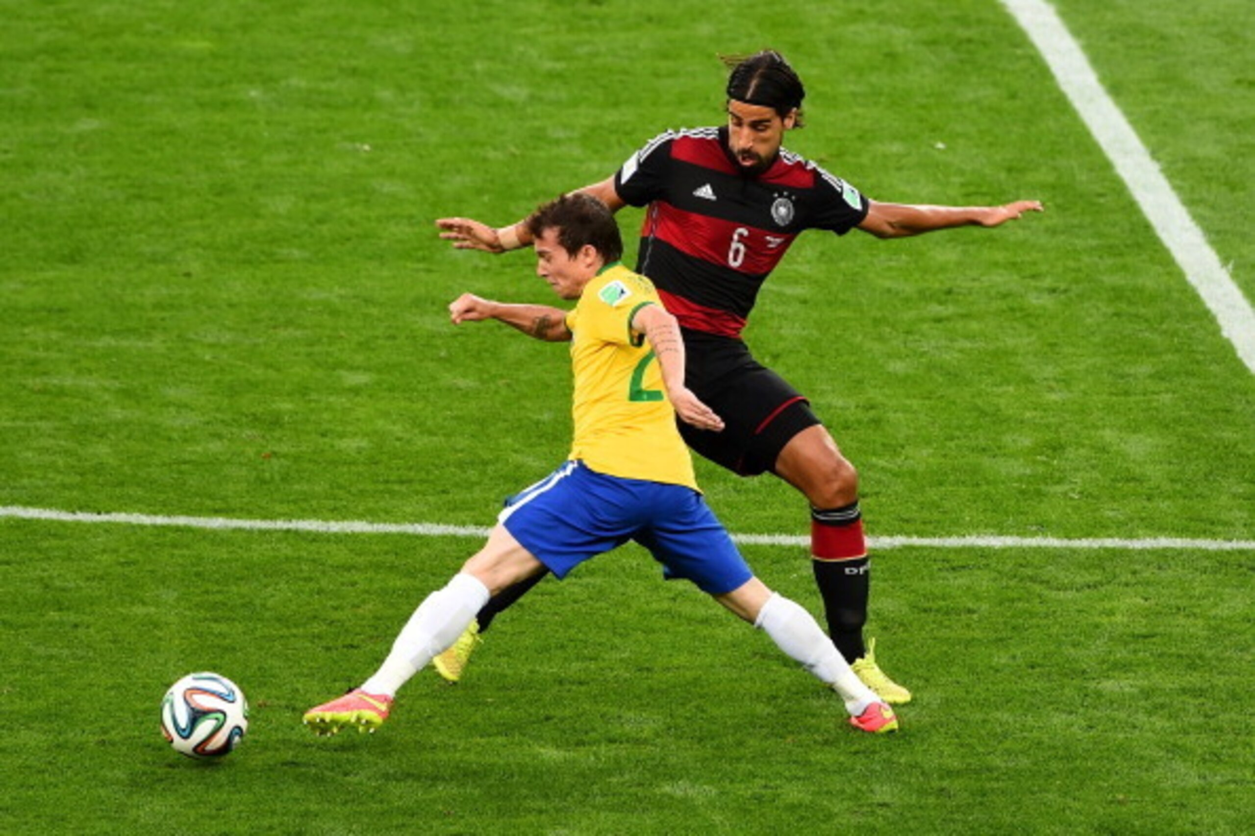 BELO HORIZONTE, BRAZIL - JULY 08:  Bernard  of Brazil and Sami Khedira of Germany compete for the ball during the 2014 FIFA World Cup Brazil Semi Final match between Brazil and Germany at Estadio Mineirao on July 8, 2014 in Belo Horizonte, Brazil.  (Photo