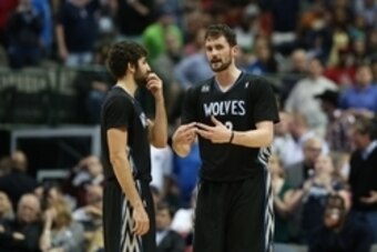 Mar 19, 2014; Dallas, TX, USA; Minnesota Timberwolves forward Kevin Love (42) talks with guard Ricky Rubio (9) during a break in the game against the Dallas Mavericks at American Airlines Center. Mandatory Credit: Matthew Emmons-USA TODAY Sports