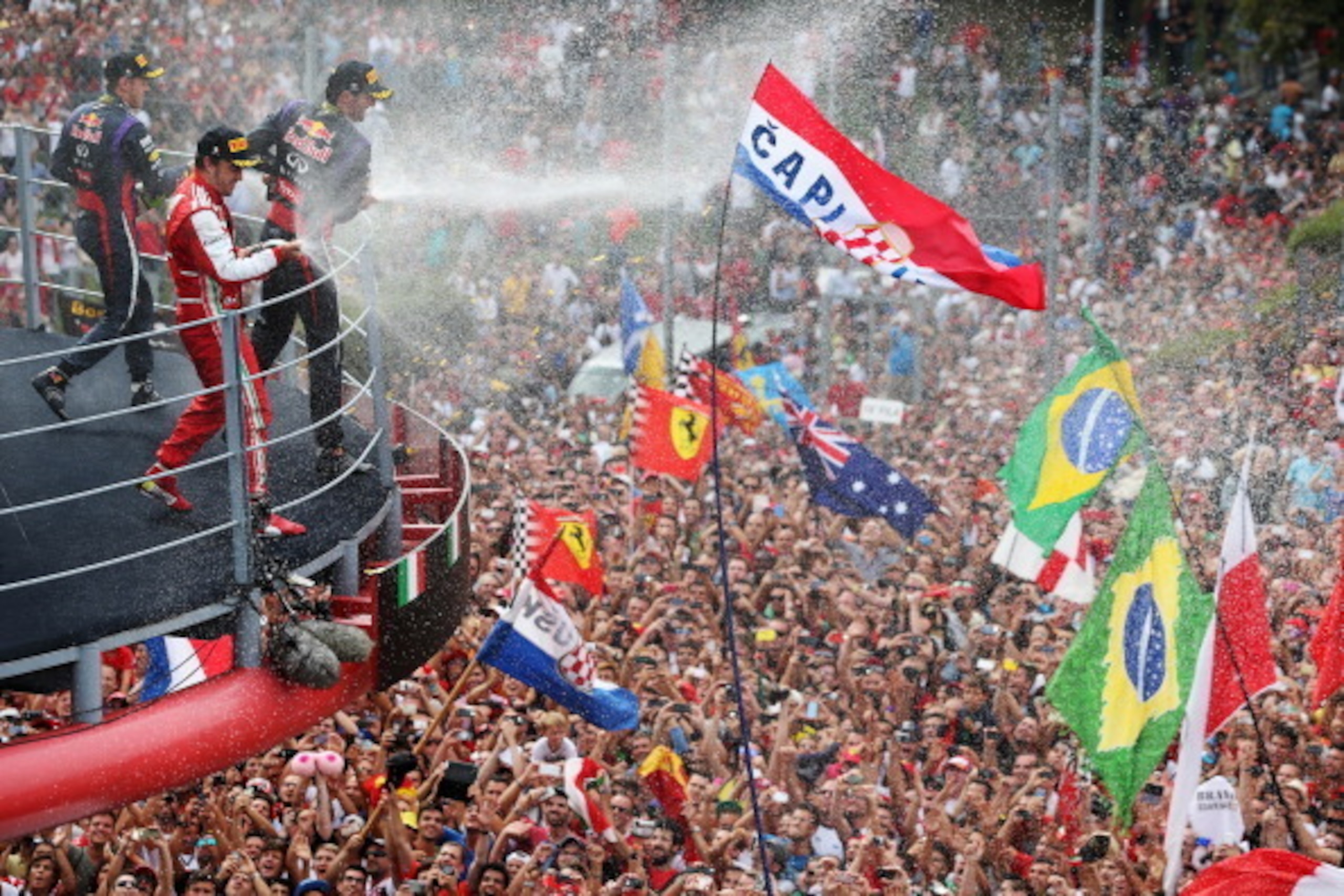 MONZA, ITALY - SEPTEMBER 08: Race winner Sebastian Vettel (L) of Germany and Infiniti Red Bull Racing, second placed Fernando Alonso (C) of Spain and Ferrari and third placed Mark Webber (R) of Australia and Infiniti Red Bull Racing celebrate on the podi MONZA, ITALY - SEPTEMBER 08: Race winner Sebastian Vettel (L) of Germany and Infiniti Red Bull Racing, second placed Fernando Alonso (C) of Spain and Ferrari and third placed Mark Webber (R) of Australia and Infiniti Red Bull Racing celebrate on the podi