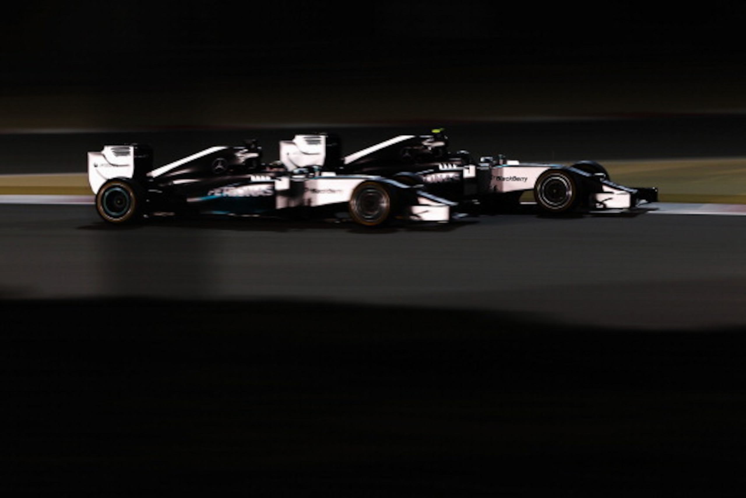 SAKHIR, BAHRAIN - APRIL 06: Nico Rosberg (R) of Germany and Mercedes GP and team mate Lewis Hamilton (L) of Great Britain and Mercedes GP battle for the lead during Bahrain Formula One Grand Prix at the Bahrain International Circuit on April 6, 2014 in SAKHIR, BAHRAIN - APRIL 06: Nico Rosberg (R) of Germany and Mercedes GP and team mate Lewis Hamilton (L) of Great Britain and Mercedes GP battle for the lead during Bahrain Formula One Grand Prix at the Bahrain International Circuit on April 6, 2014 in