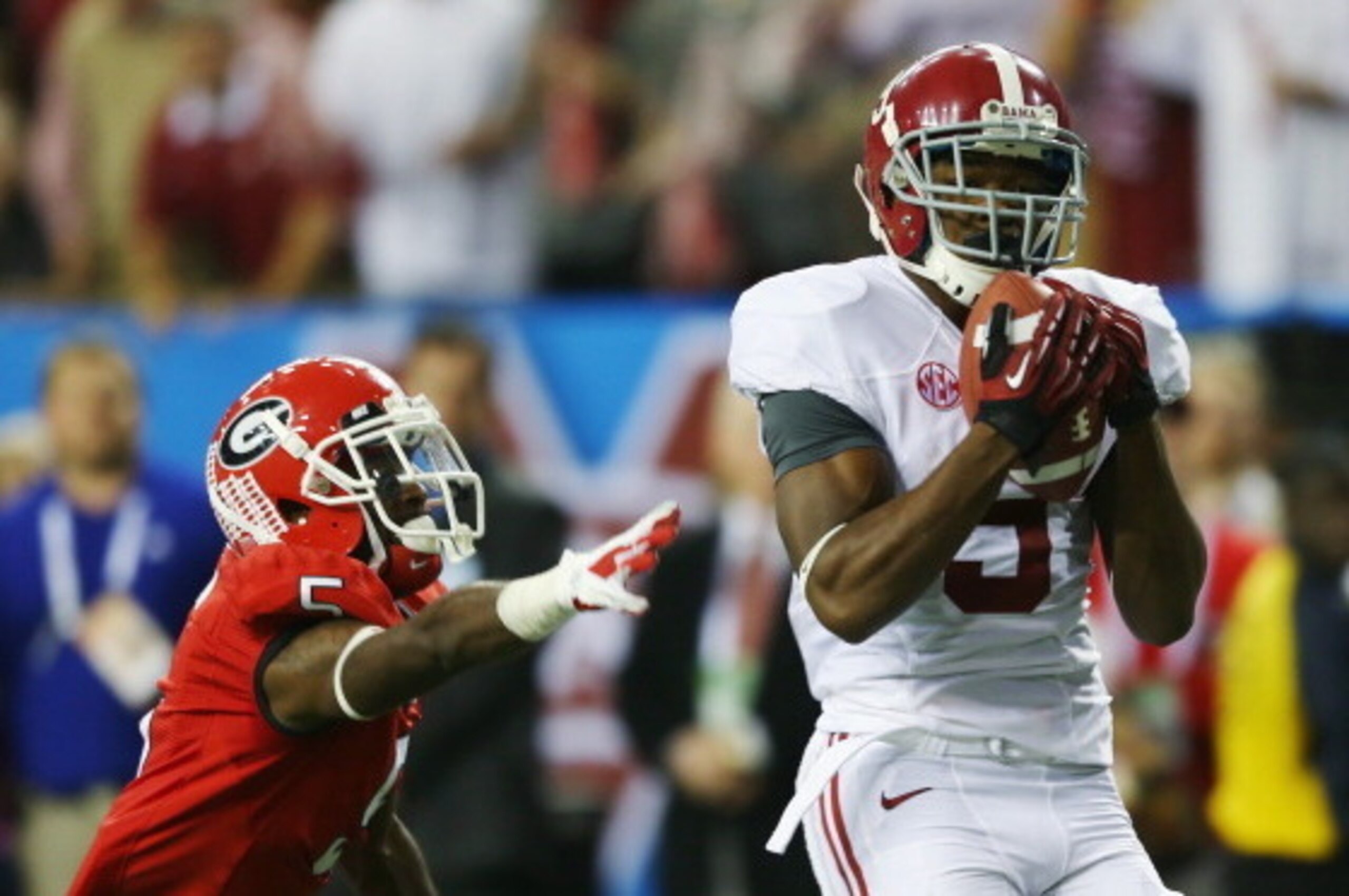 ATLANTA, GA - DECEMBER 01: Wide receiver Amari Cooper #9 of the Alabama Crimson Tide catches a fourth quarter touchdown pass in front of defensive back Damian Swann #5 of the Georgia Bulldogs during the SEC Championship Game at the Georgia Dome on Decembe