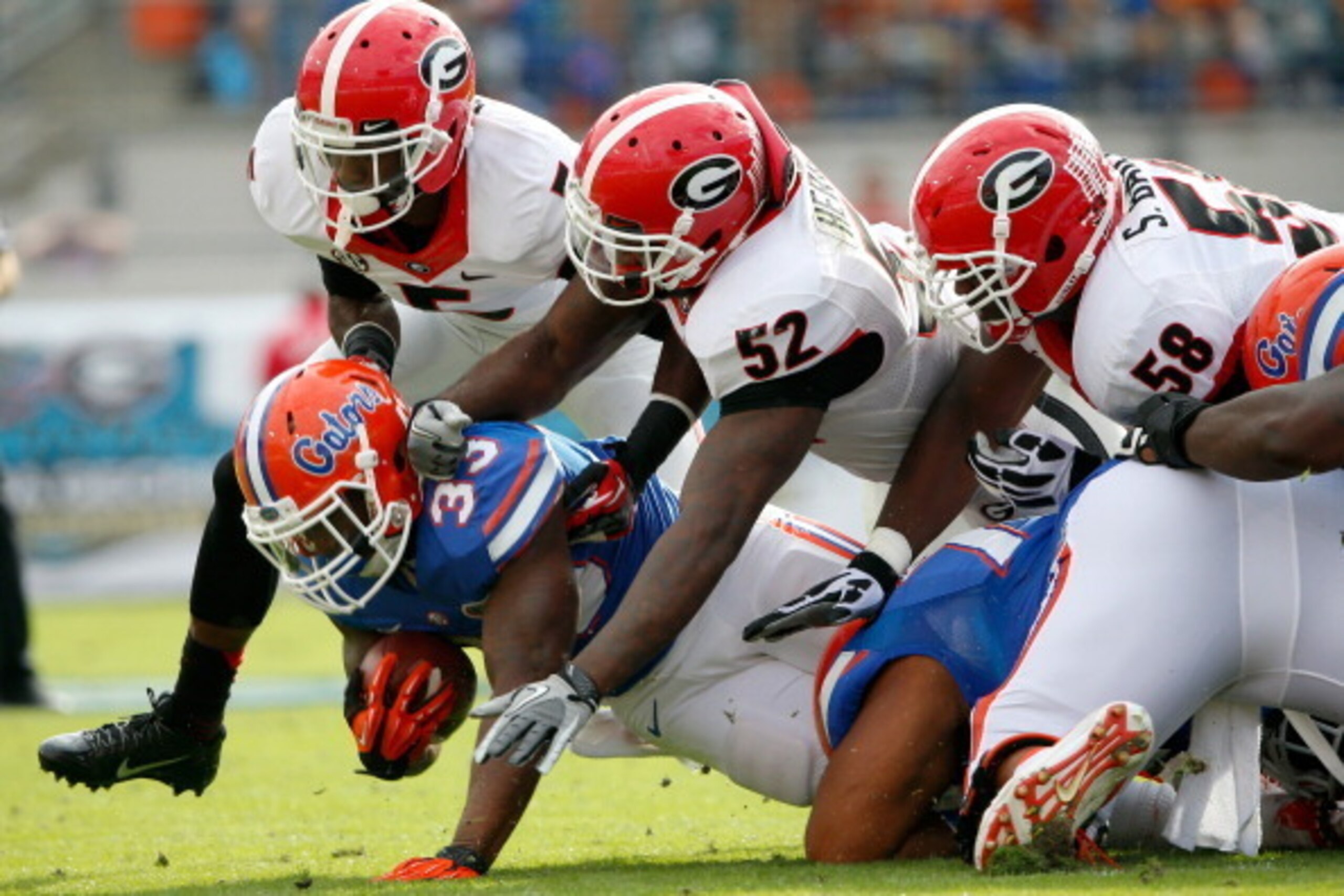 JACKSONVILLE, FL - NOVEMBER 02:  Amarlo Herrera #52 of the Georgia Bulldogs tackles Mack Brown #33 of the Florida Gators during the game at EverBank Field on November 2, 2013 in Jacksonville, Florida.  (Photo by Sam Greenwood/Getty Images)