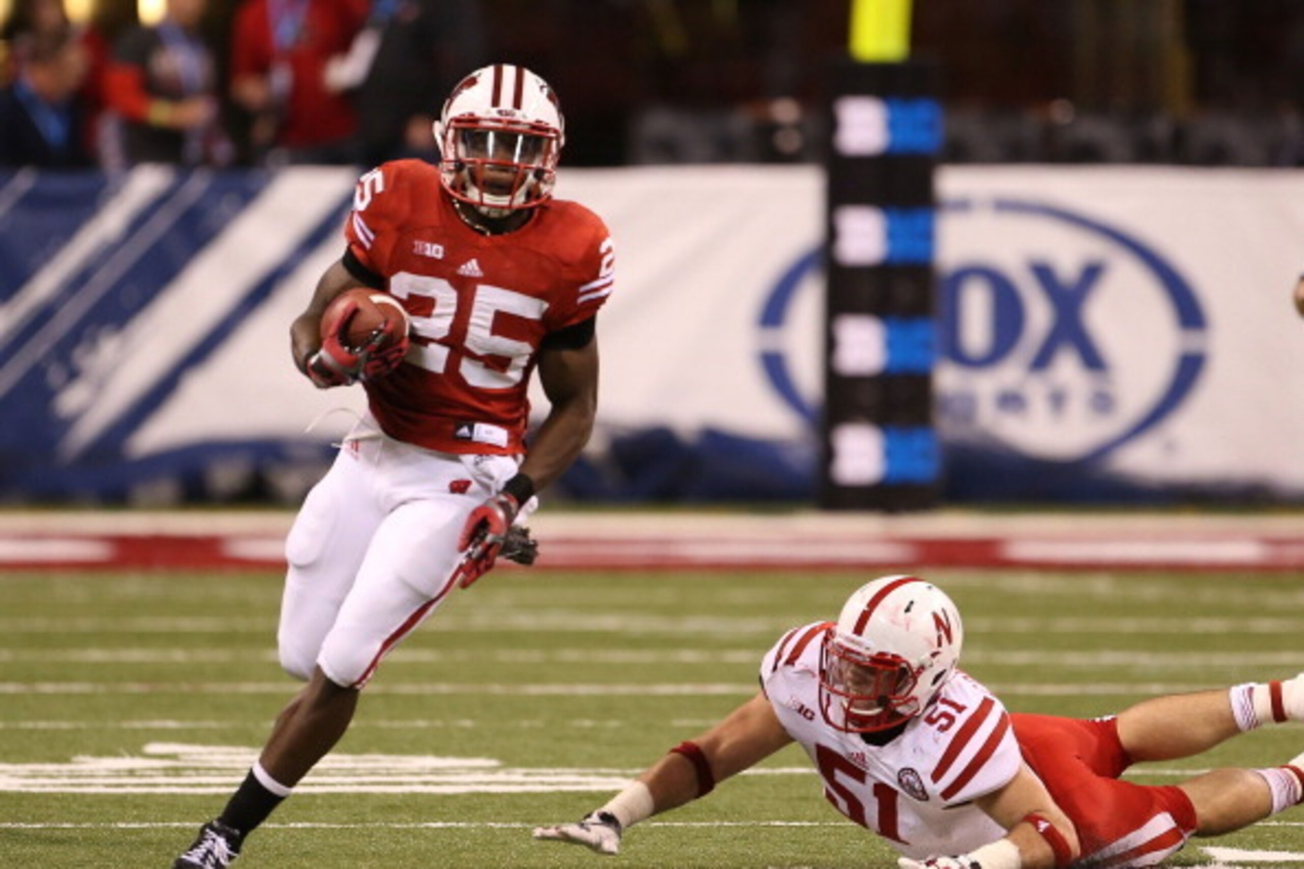 INDIANAPOLIS, IN - DECEMBER 01: Marvin Gordon #25 of the Wisconsin Badgers runs for a first down during the second quarter of the Big Ten Championship game against the Nebraska Cornhuskers at Lucas Oil Stadium on December 1, 2012 in Indianapolis, Indiana.
